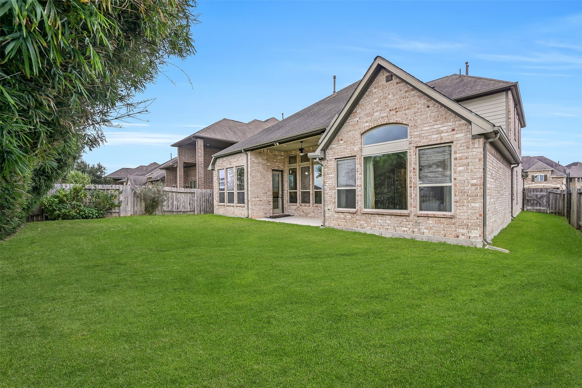1640 Longwood Glen Lane, Friendswood, TX 77546 Out back, a spacious fenced lawn offers plenty of room for outdoor activities, with established bamboo providing privacy-enhancing screening along the rear fence. A covered patio with gas stub adds a convenient spot for grilling or relaxing outdoors.