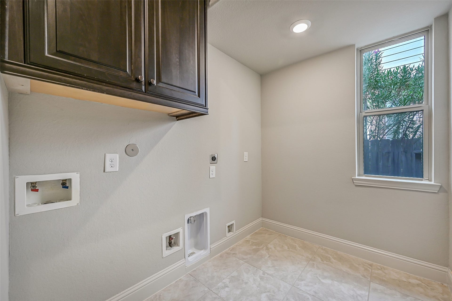 1640 Longwood Glen Lane, Friendswood, TX 77546 Tucked near the garage entrance, the spacious utility room offers both gas & electric dryer connections, overhead cabinetry, a utility closet & room for an additional refrigerator. A side-facing window brings in natural light, too!