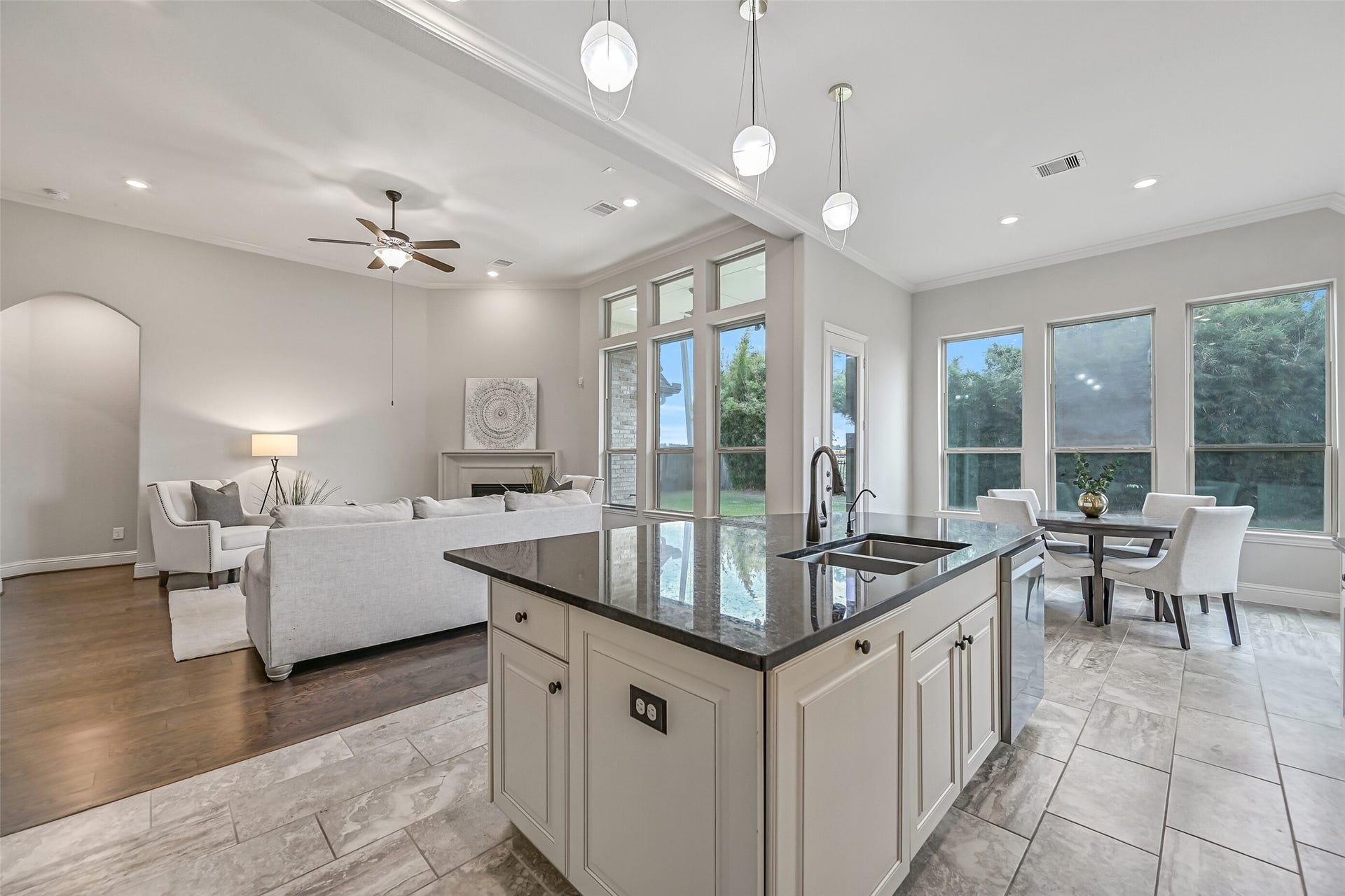 1640 Longwood Glen Lane, Friendswood, TX 77546 This view really captures the open flow between the kitchen, breakfast room & family room! A wall of windows brings in natural light, while the granite island provides a convenient connection between the living spaces.