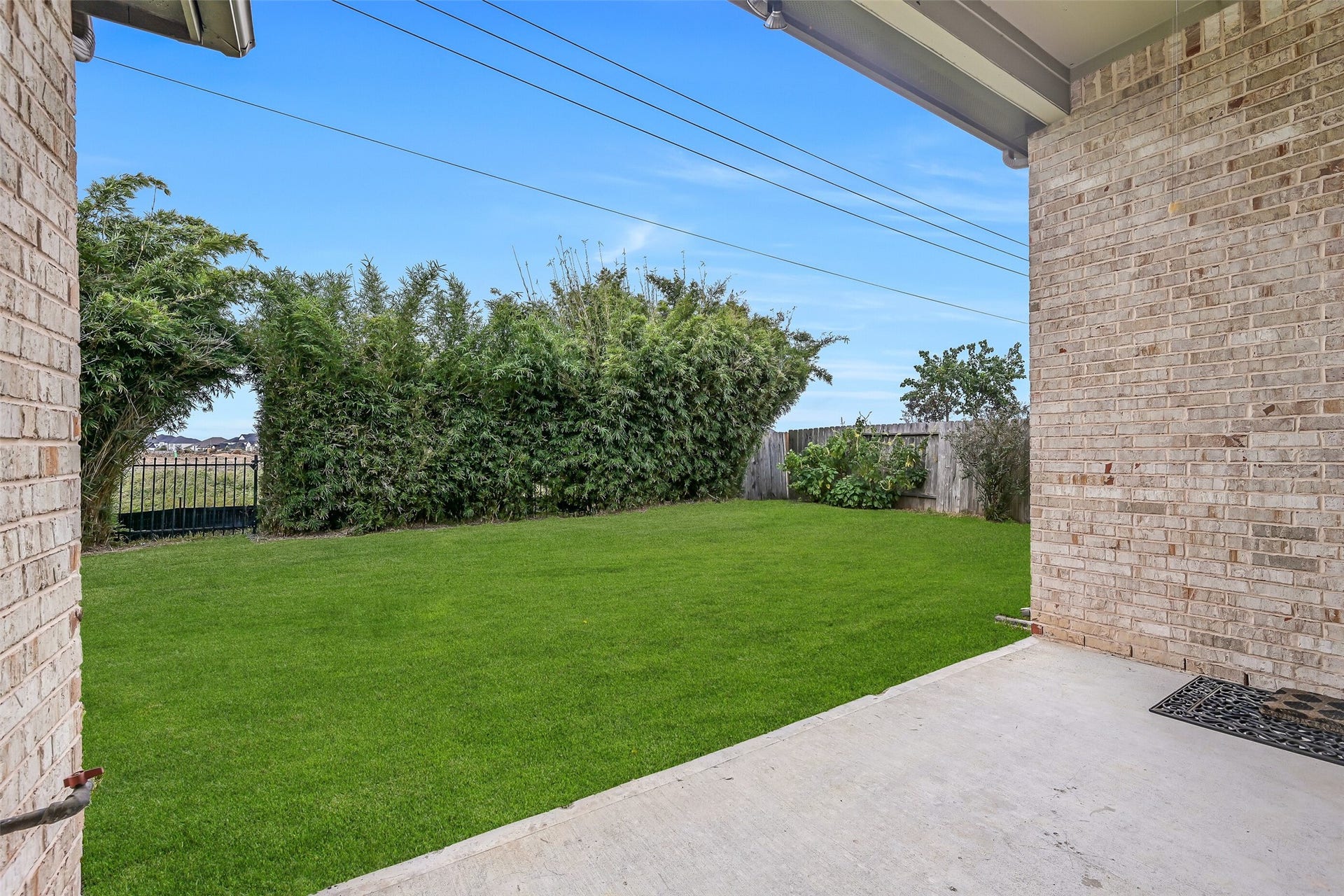 1640 Longwood Glen Lane, Friendswood, TX 77546 Step out onto the covered back patio, complete with a ceiling fan & gas stub for grilling! The spacious grassy backyard is framed by established bamboo along the rear fence, providing privacy-enhancing screening and a lovely green backdrop.