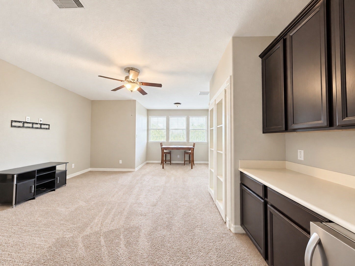 The spacious upstairs game room offers a versatile setting for games, entertaining, or a comfortable second living area.