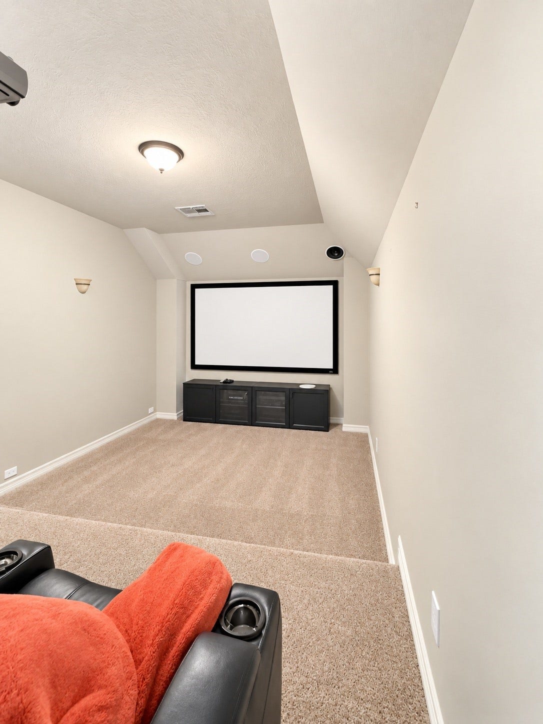 Tucked behind a cleverly concealed bookcase, the private media room offers a unique entertainment retreat for movie nights and unforgettable gatherings.