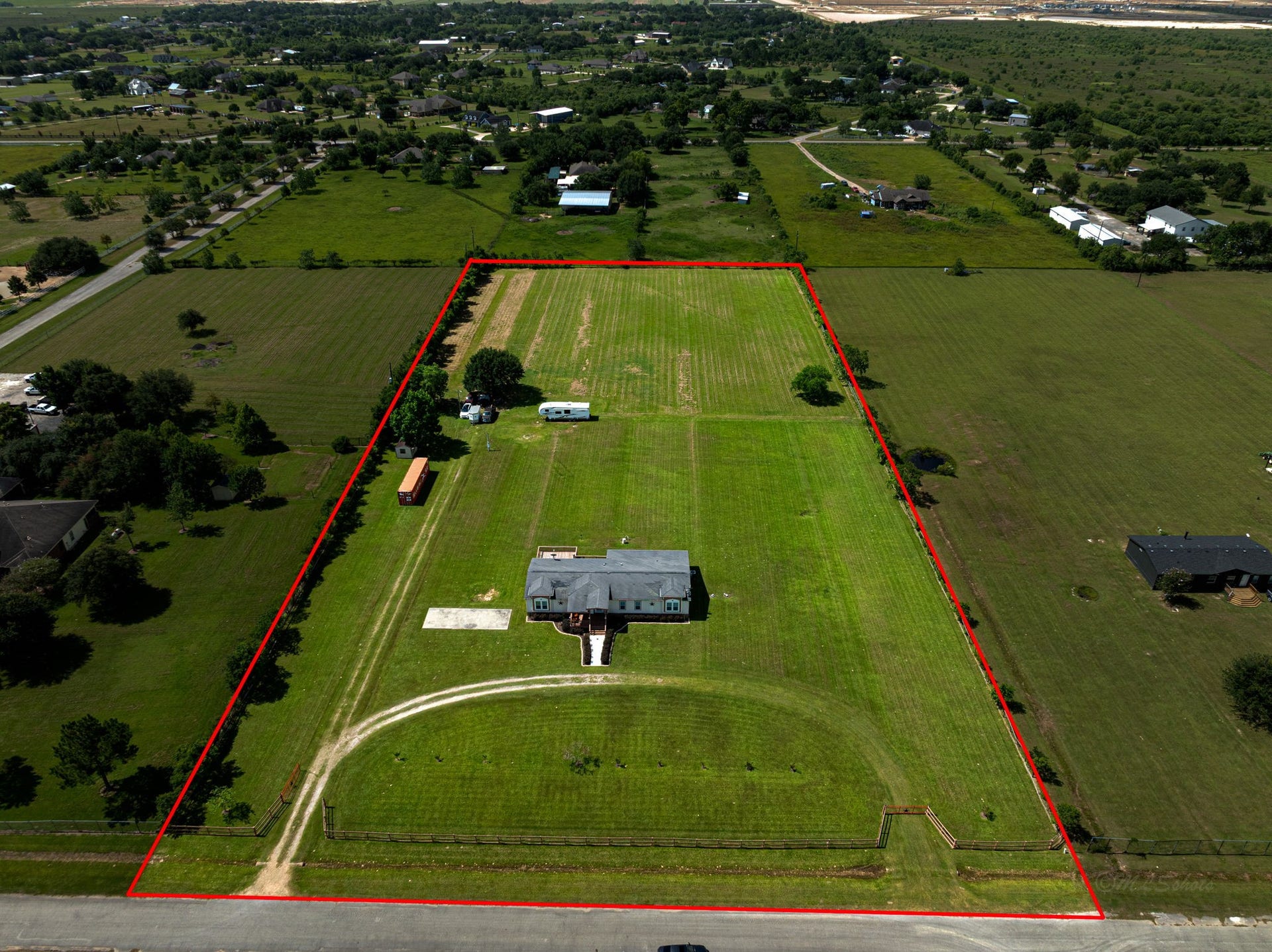 Aerial view showcasing the full 5-acre property and wide-open space.