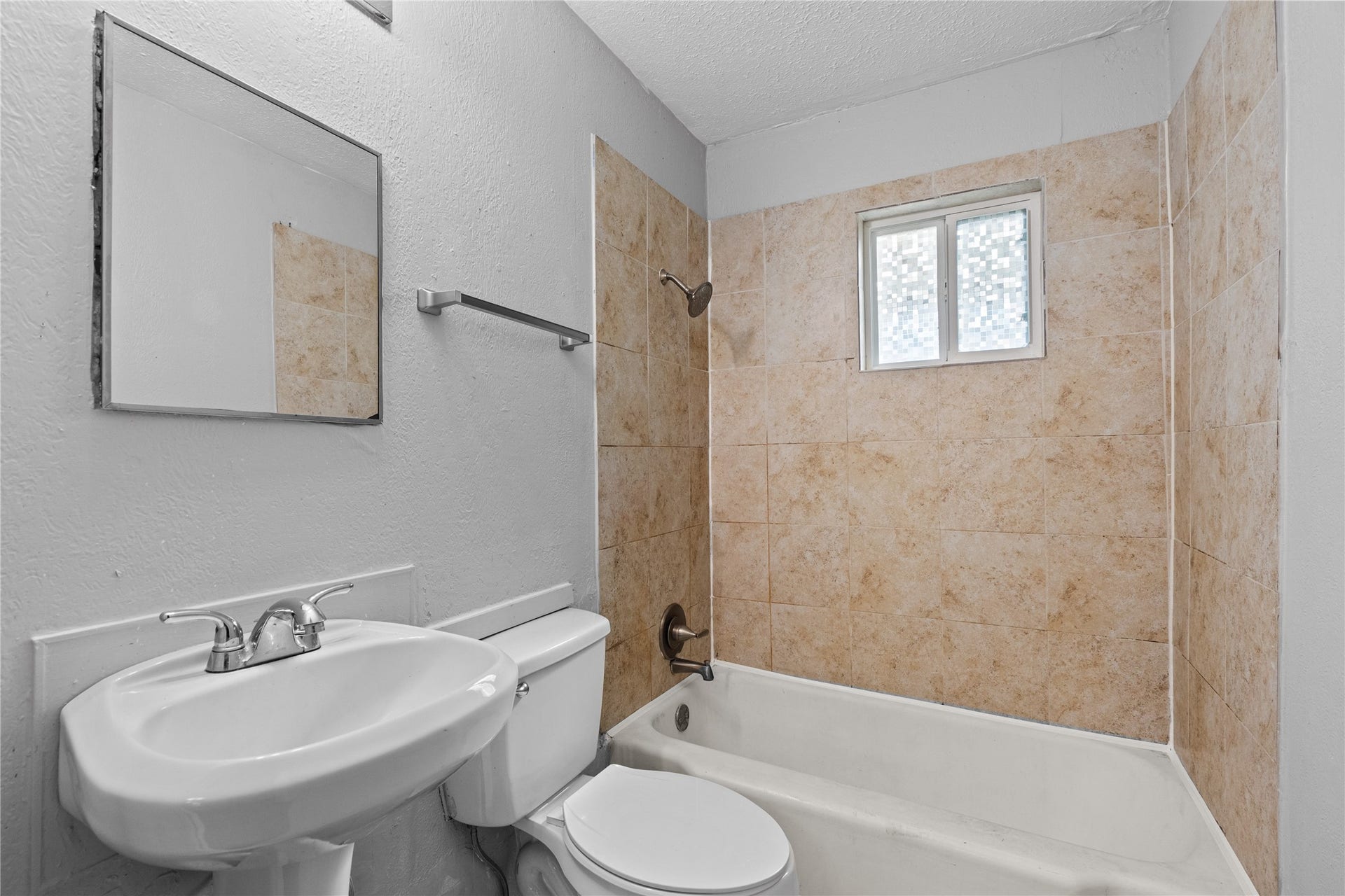 4808 35th Street E, Dickinson, TX 77539 Bathroom with pedestal sink and tiled tub/shower combo