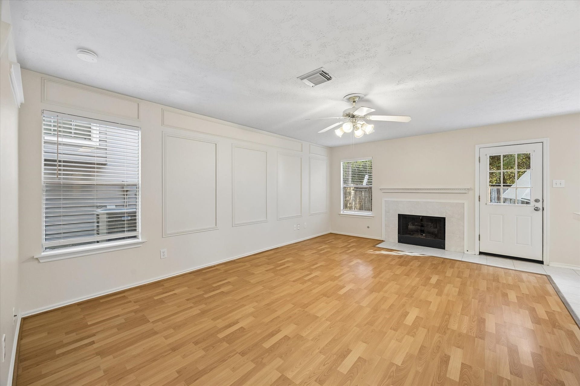 139 Anise Tree Place, Spring, TX 77382 Large space with view of the charming fireplace and outdoors.
