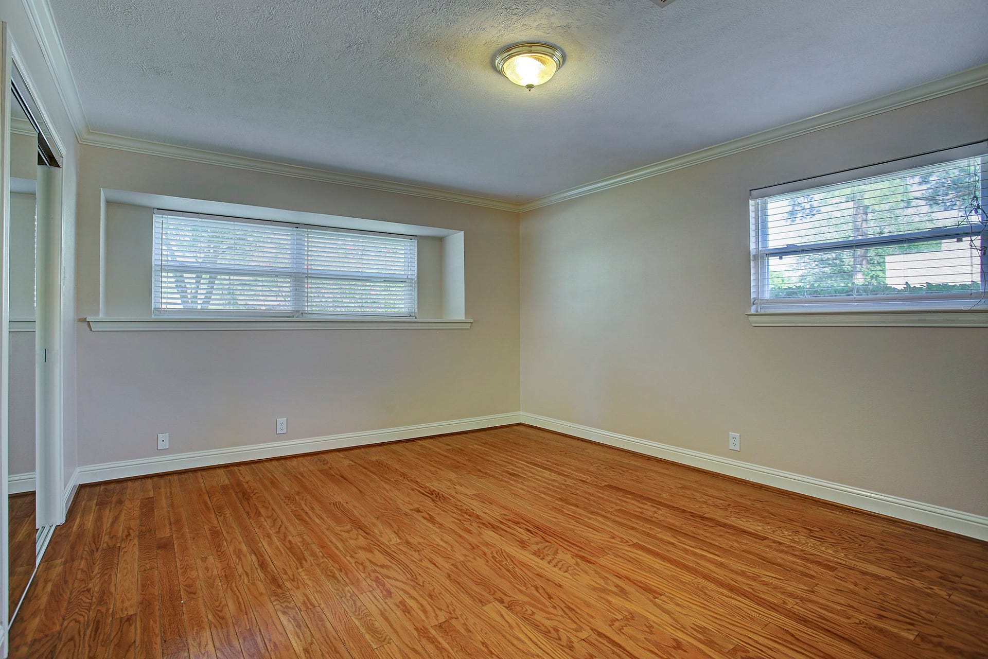 Windows on two walls bring the light; hardwood floors bring the warmth. Your furniture gets to do the rest.