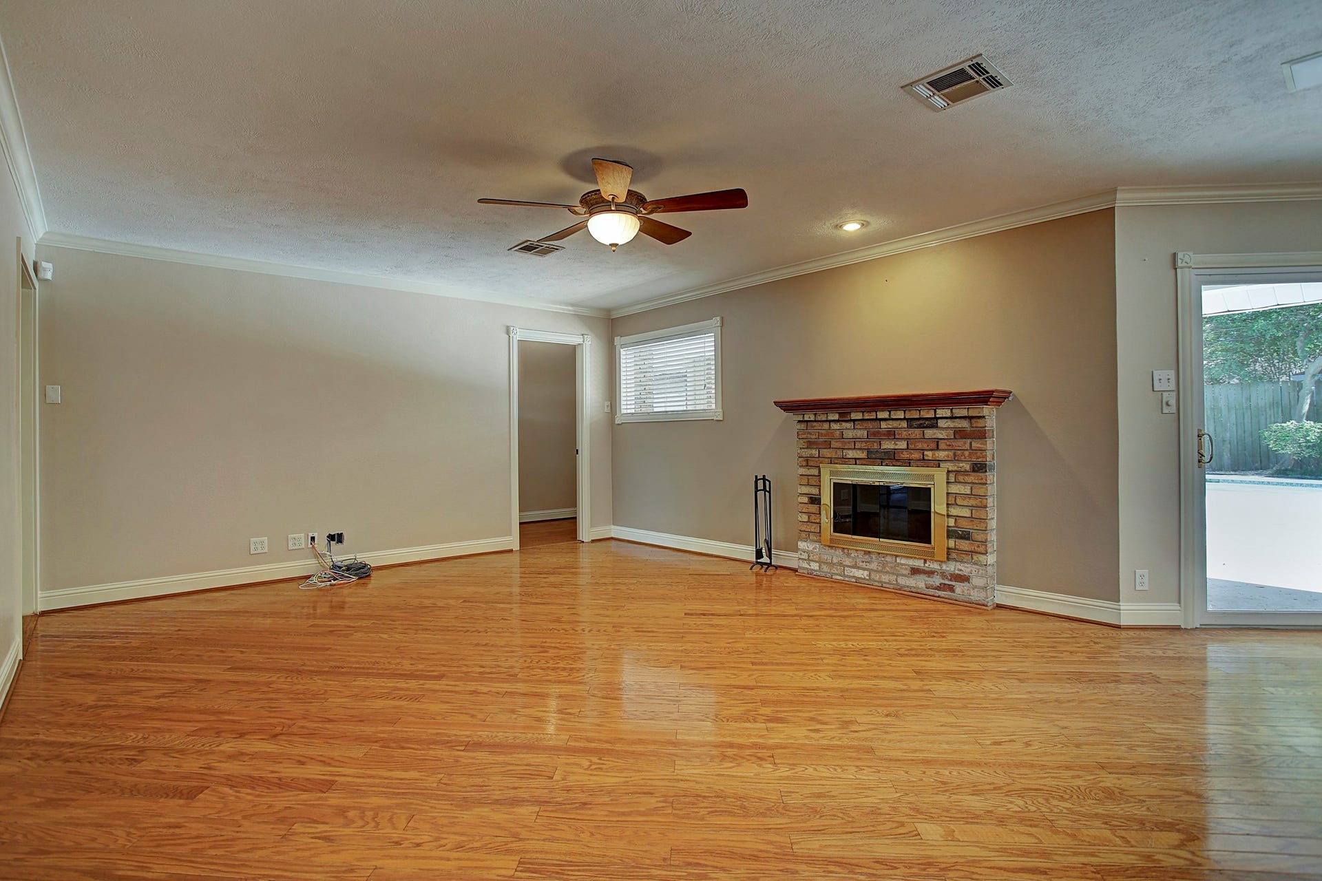 Fireplace weather or pool weather? With the patio just outside, this living room is ready for either.