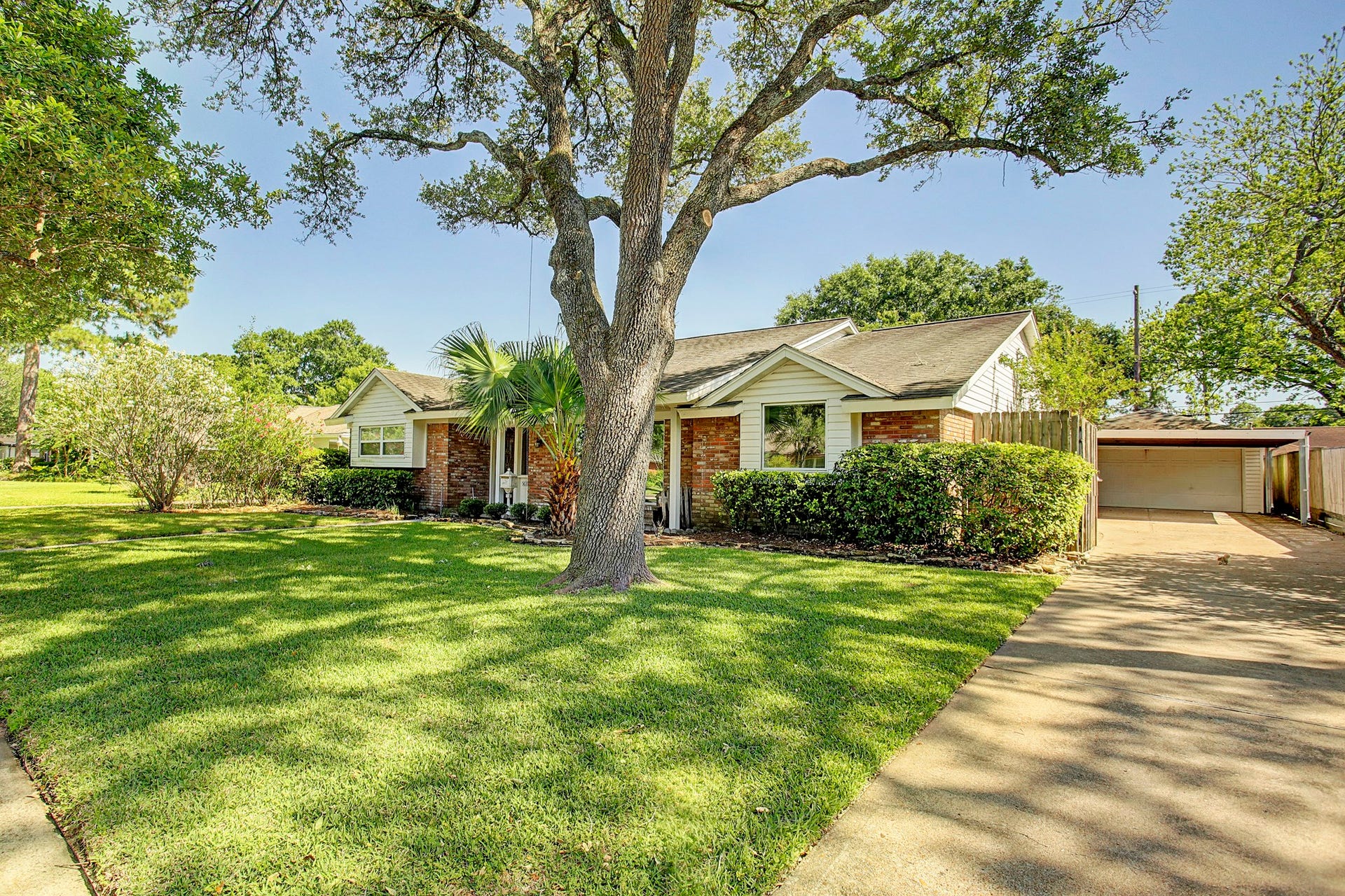A long driveway, covered carport, and two-car garage give you parking options without sacrificing curb appeal.