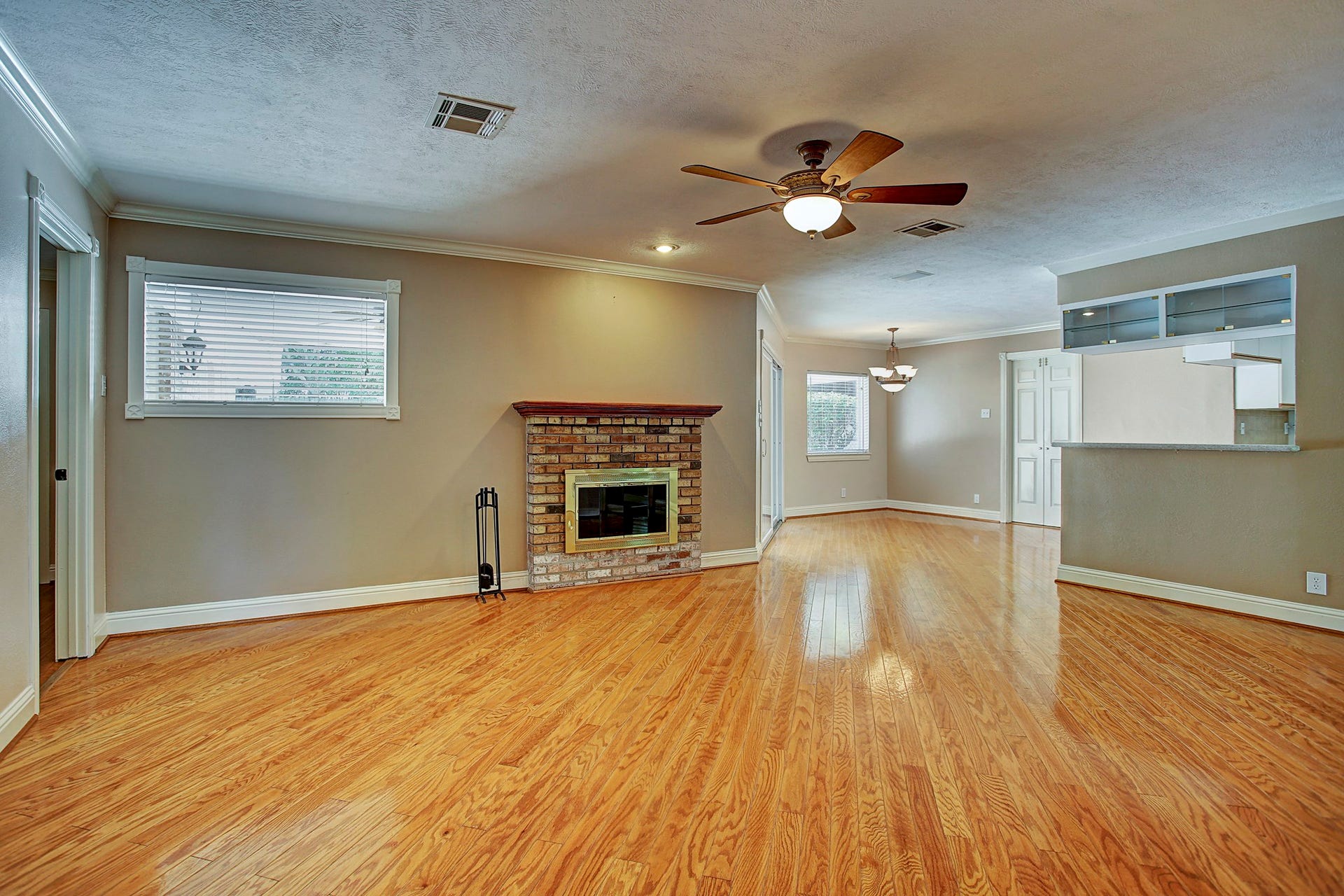 Get the big sectional. This generous living room has the space for it, with hardwood floors and a brick fireplace to pull it all together.