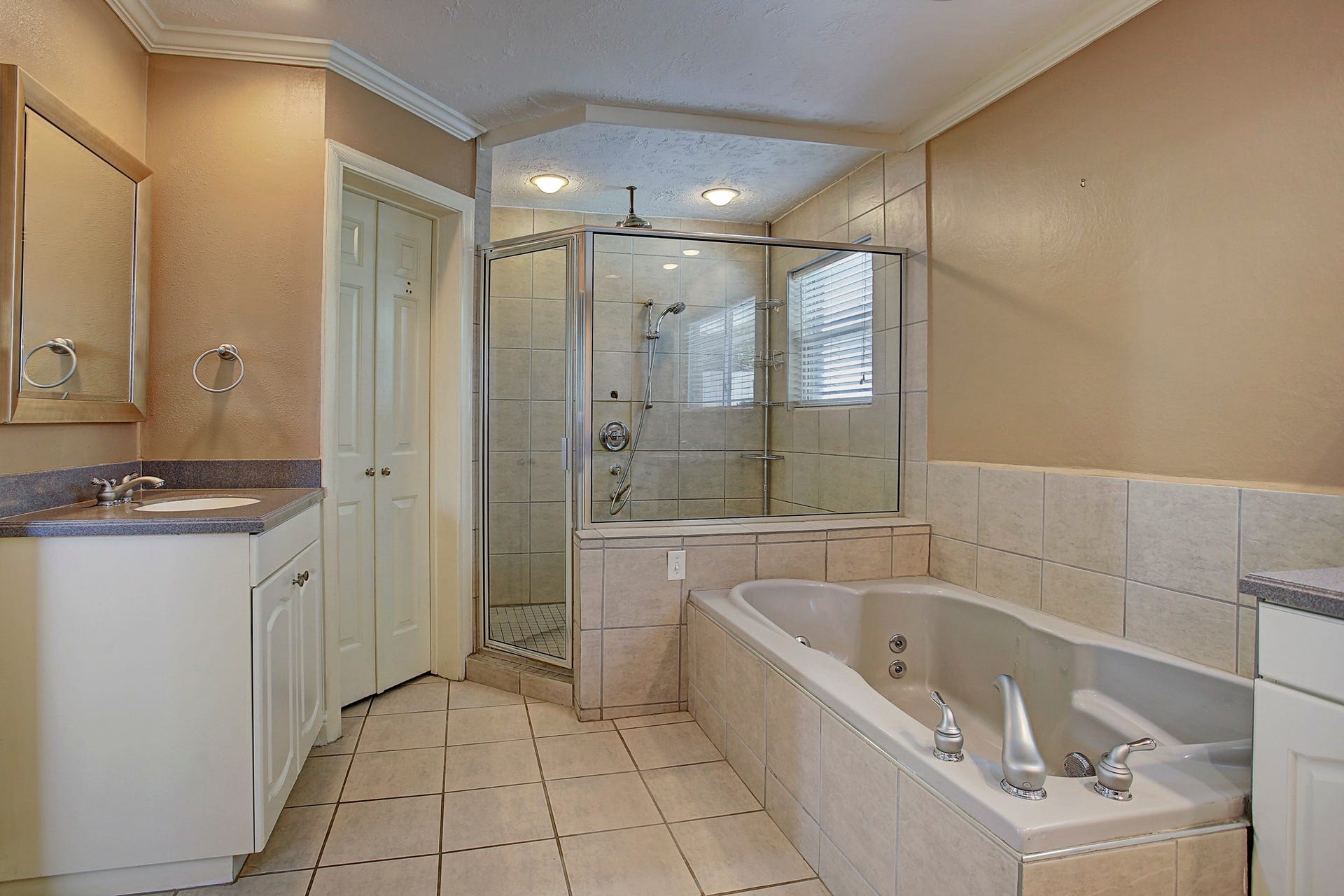 Separate sinks, a soaking tub, and a glass-enclosed shower mean you can claim your counter space and keep it.