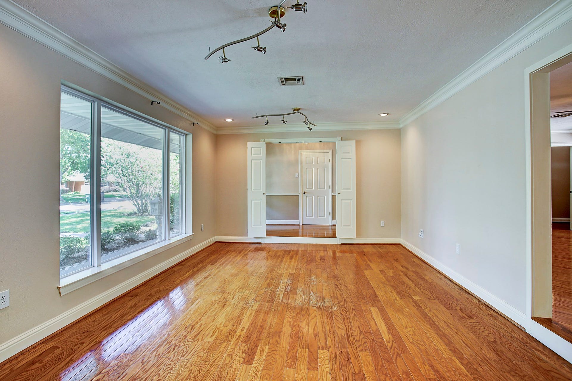 Big windows and hardwood floors set the scene. Bring the linen curtains, comfortable seating, and your own sense of style.