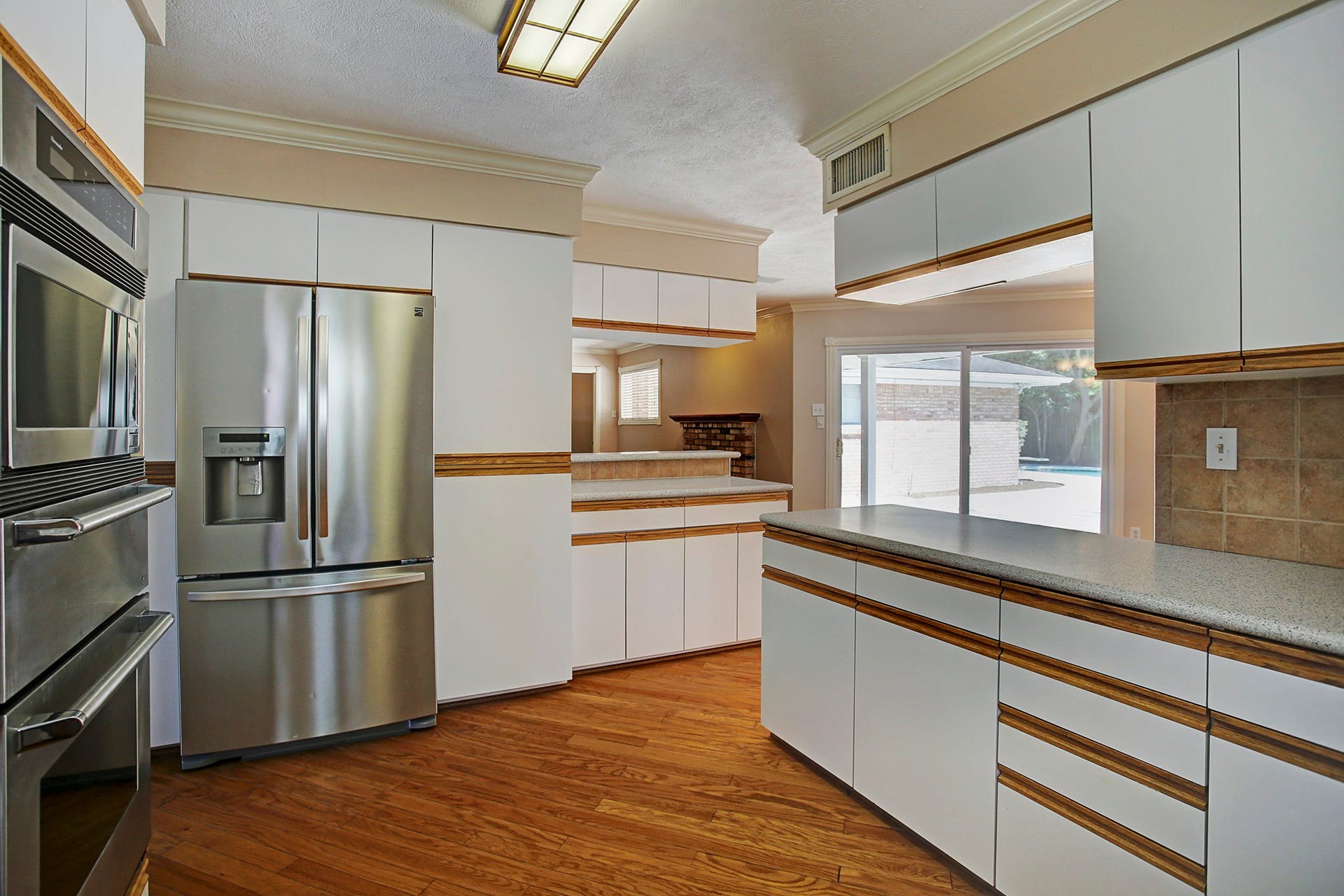 A kitchen pass-through keeps the conversation going while you cook, with a backyard view to keep an eye on the pool plans.