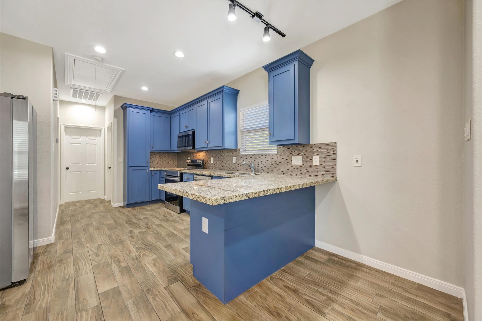 Kitchen with custom built cabinets and bar area