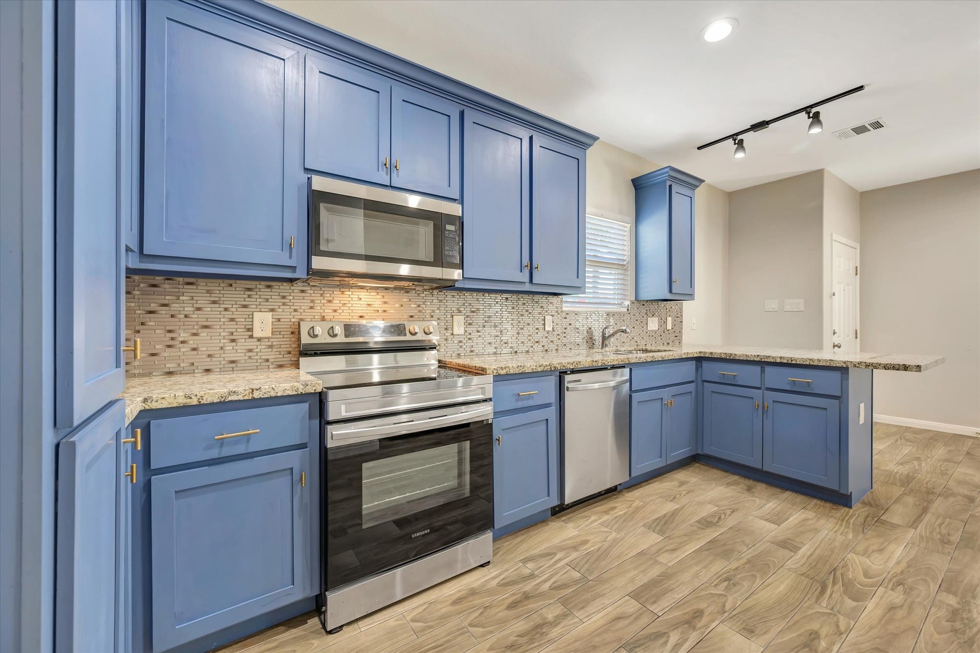 Kitchen also offers plenty of cabinets and storage