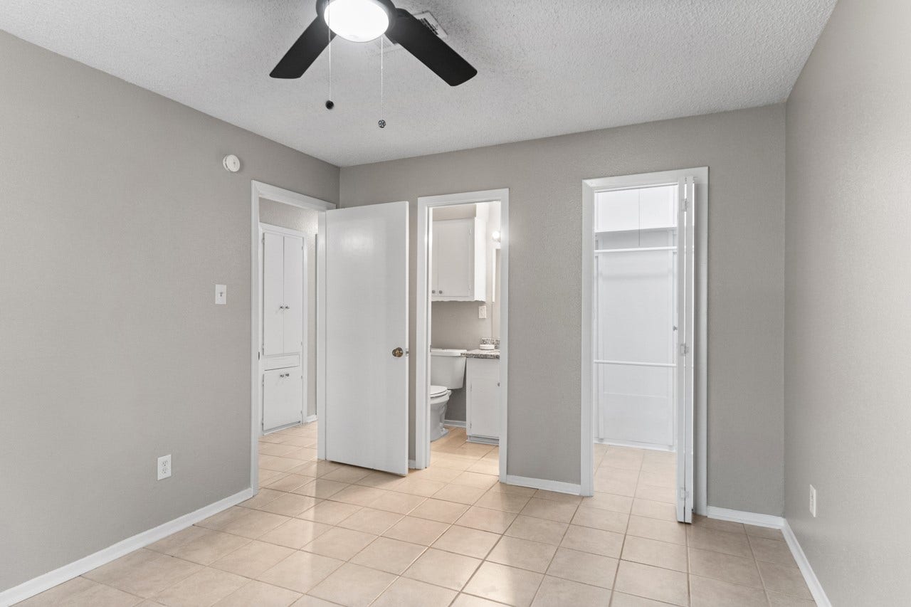 745 Dezso Drive, Alvin, TX 77511 Primary bedroom with a peak into the bathroom and walk-in closet.