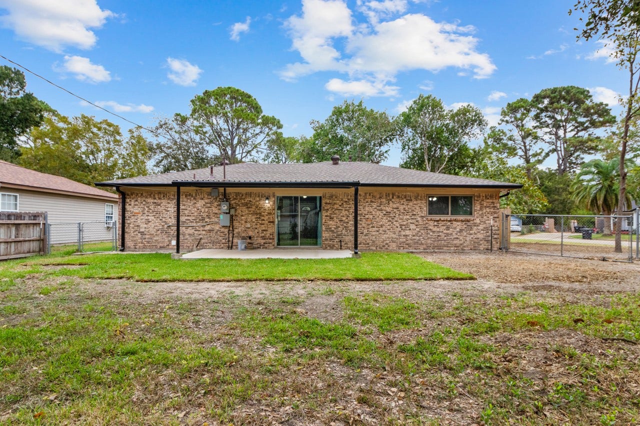 745 Dezso Drive, Alvin, TX 77511 View of the yard and the back of the home. It's on a large corner lot.