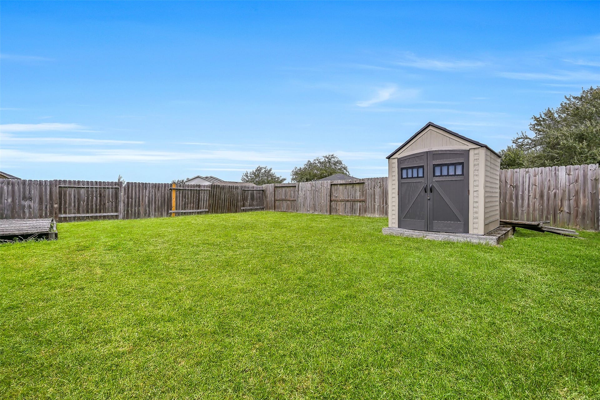 9022 Amberjack Drive, Texas City, TX 77591 Another view emphasizes the generous backyard and freestanding storage shed, with plenty of open lawn remaining for recreation and outdoor activities.