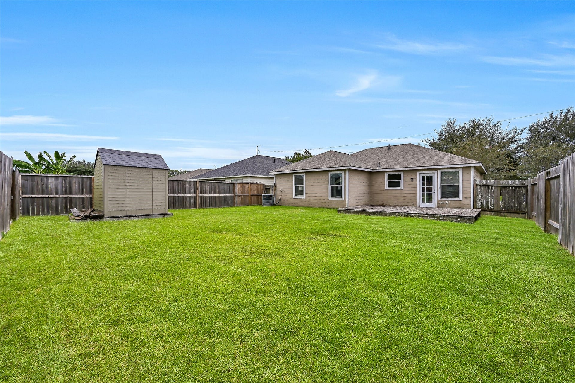 9022 Amberjack Drive, Texas City, TX 77591 There's plenty of room to spread out in this spacious fenced backyard, with a broad expanse of lawn offering possibilities for pets, play, gardening, or future outdoor improvements.