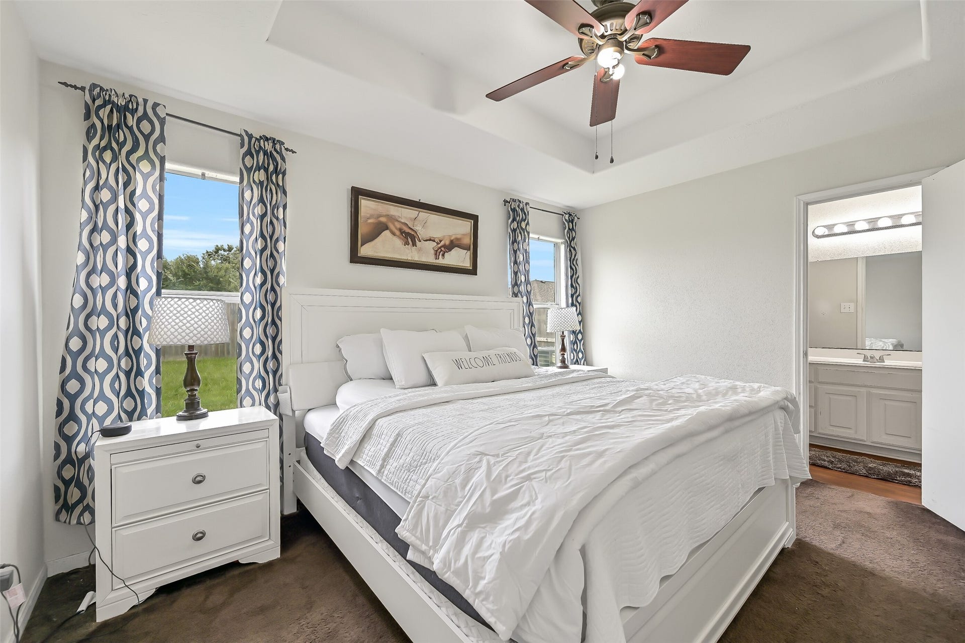 9022 Amberjack Drive, Texas City, TX 77591 The primary bedroom offers a spacious retreat with a tray ceiling, ceiling fan, and two windows that fill the room with natural light. A private en suite bath completes the suite.