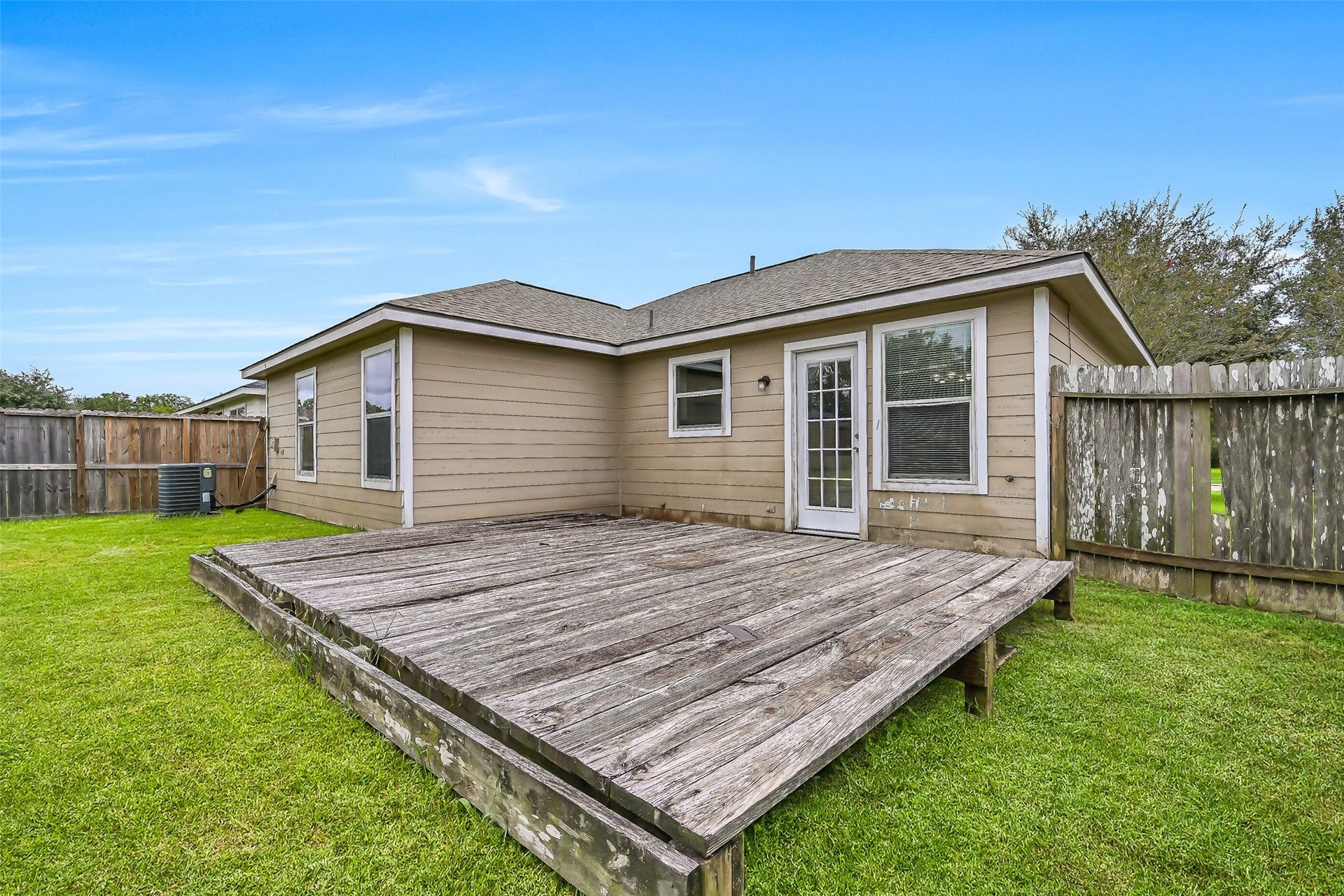 9022 Amberjack Drive, Texas City, TX 77591 A large wood deck extends from the rear of the home, creating additional outdoor space just steps from the kitchen and dining area.