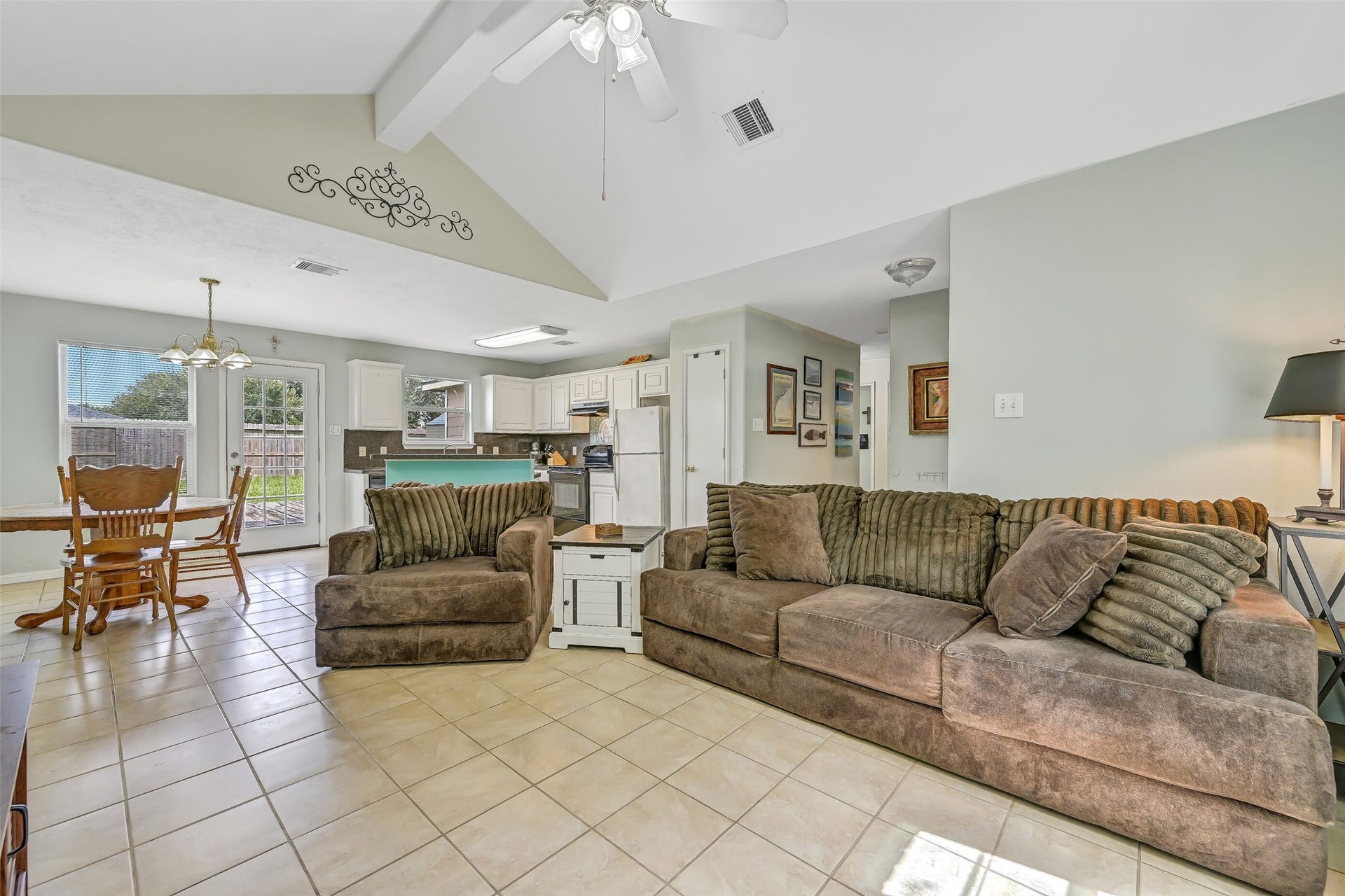 9022 Amberjack Drive, Texas City, TX 77591 A wide-angle view shows just how well the home's main living spaces connect, with the family room opening directly to the dining area and kitchen beyond.