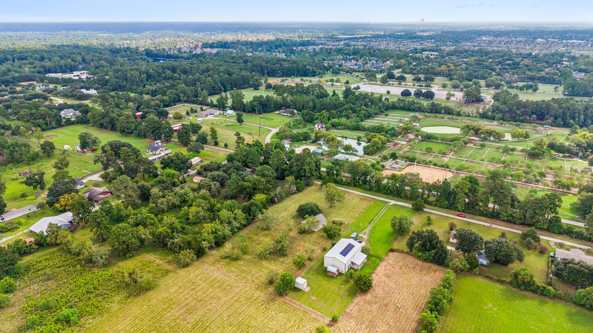 10534 Hufsmith Road, Tomball, TX 77375 Panoramic regional aerial overview highlighting the strategic location near Hufsmith Road. Exceptional transit proximity to The Woodlands, Conroe, and Magnolia, situated moments from the premier Woodlands Equestrian Club and Burroughs Park.