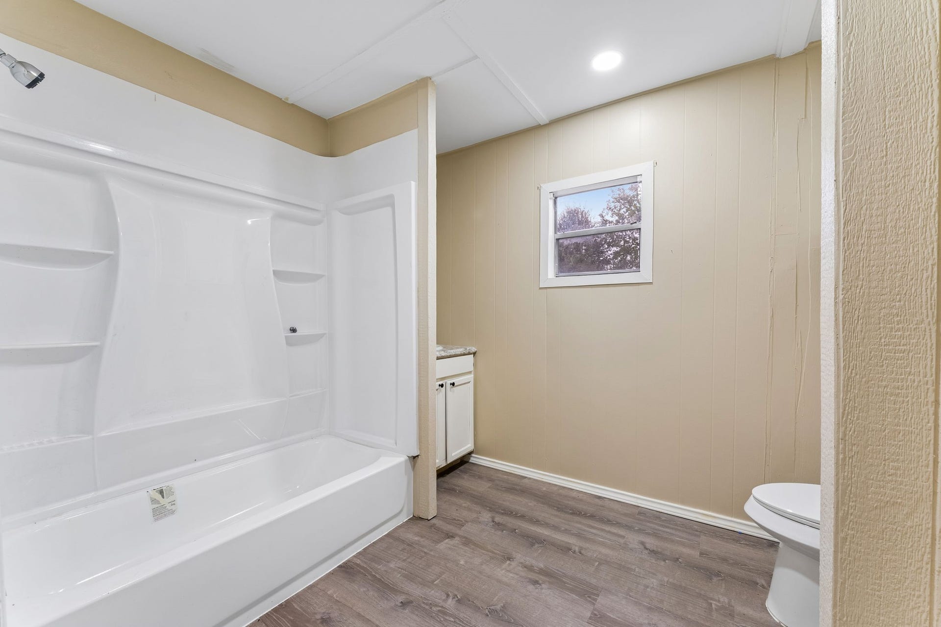 10534 Hufsmith Road, Tomball, TX 77375 Primary bath showcases the white tub/shower surround and built-in storage, creating a fresh and functional space within the suite.