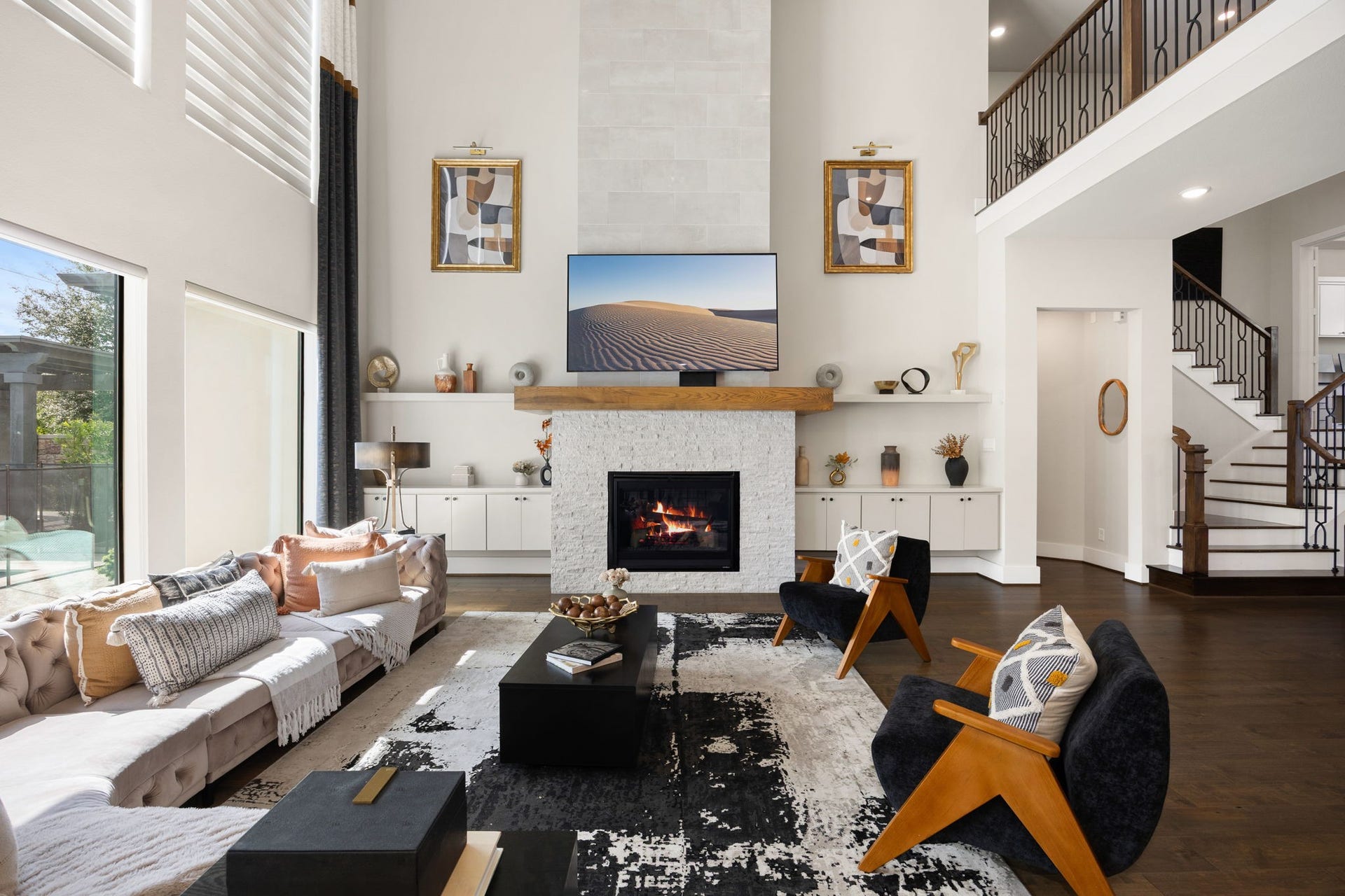 27927 Indigo Ridge Drive, Fulshear, TX 77441 Inviting living room featuring a stunning fireplace, high ceilings, and an open, airy layout.
