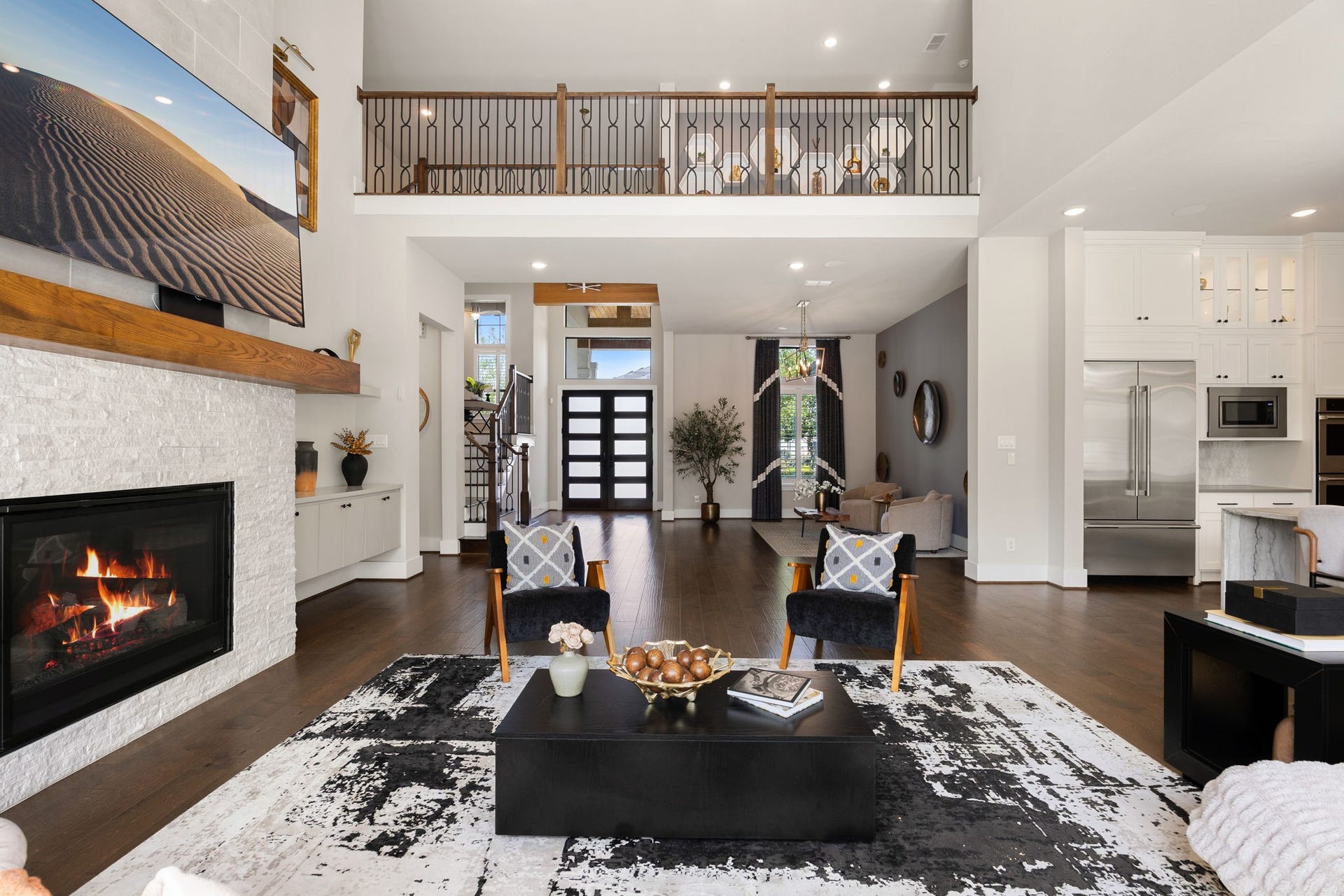 27927 Indigo Ridge Drive, Fulshear, TX 77441 Beautifully designed living space showcasing architectural details, a statement fireplace, and an open floor plan.