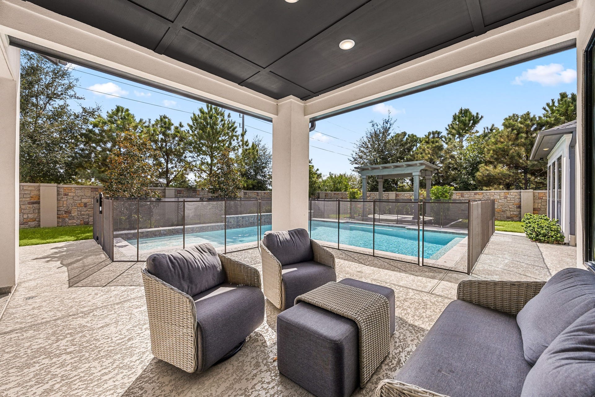 27927 Indigo Ridge Drive, Fulshear, TX 77441 Enjoy outdoor living year-round on this inviting covered patio with comfortable seating and gorgeous backyard views.