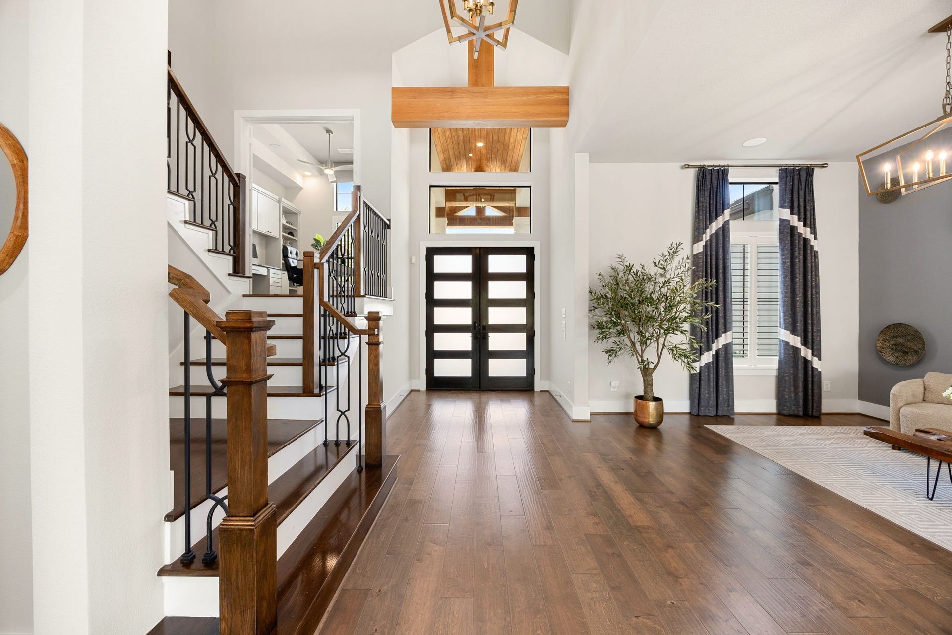 27927 Indigo Ridge Drive, Fulshear, TX 77441 Step inside to a breathtaking entryway featuring soaring ceilings, beautiful engineered hardwood flooring, custom lighting, tall windows bringing in natural light, and an elegant staircase.