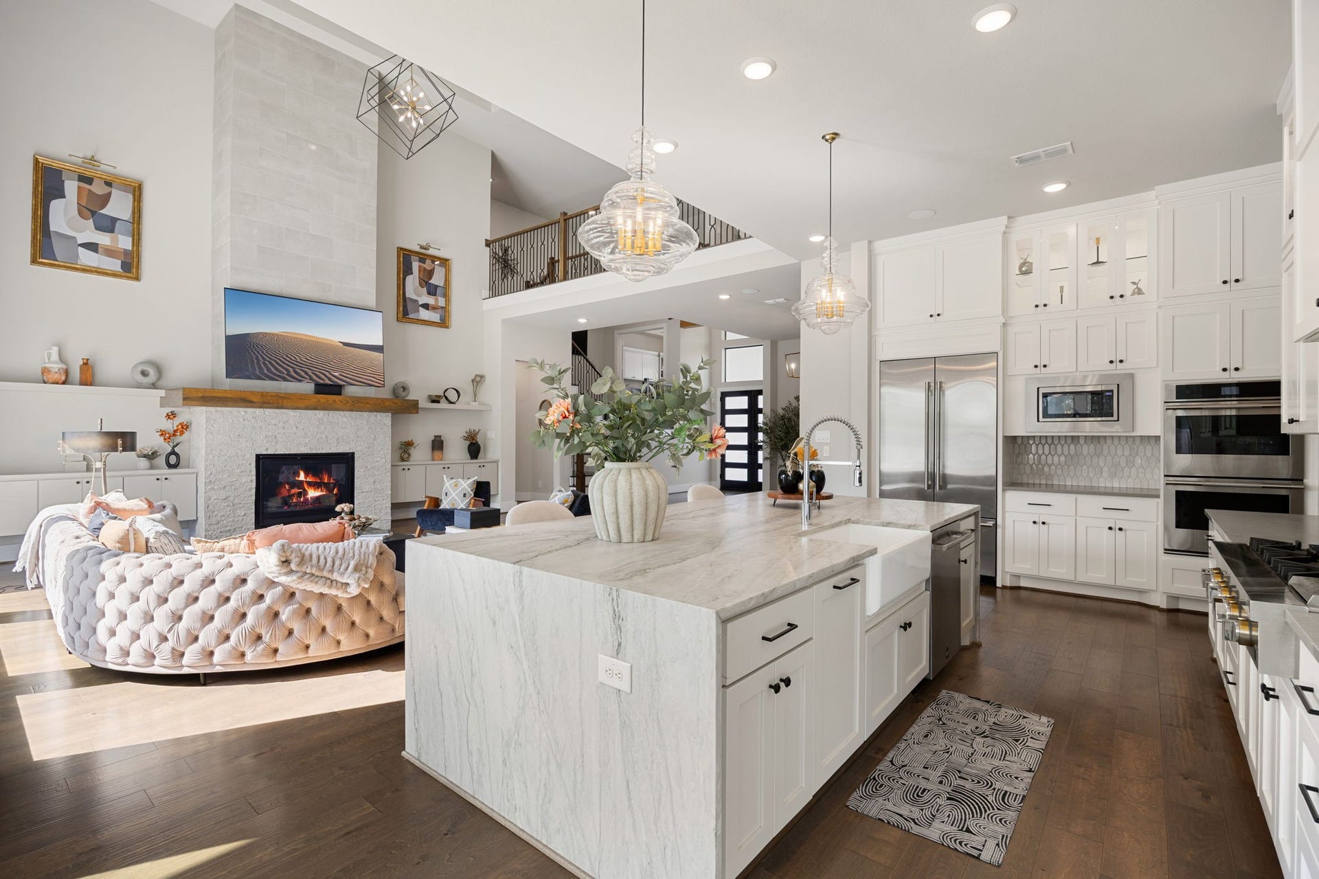 27927 Indigo Ridge Drive, Fulshear, TX 77441 Stunning kitchen with high-end JennAir appliances including built in fridge and 6 burner gas cooktop with griddle. There is seamless flow into the living areas for entertaining.