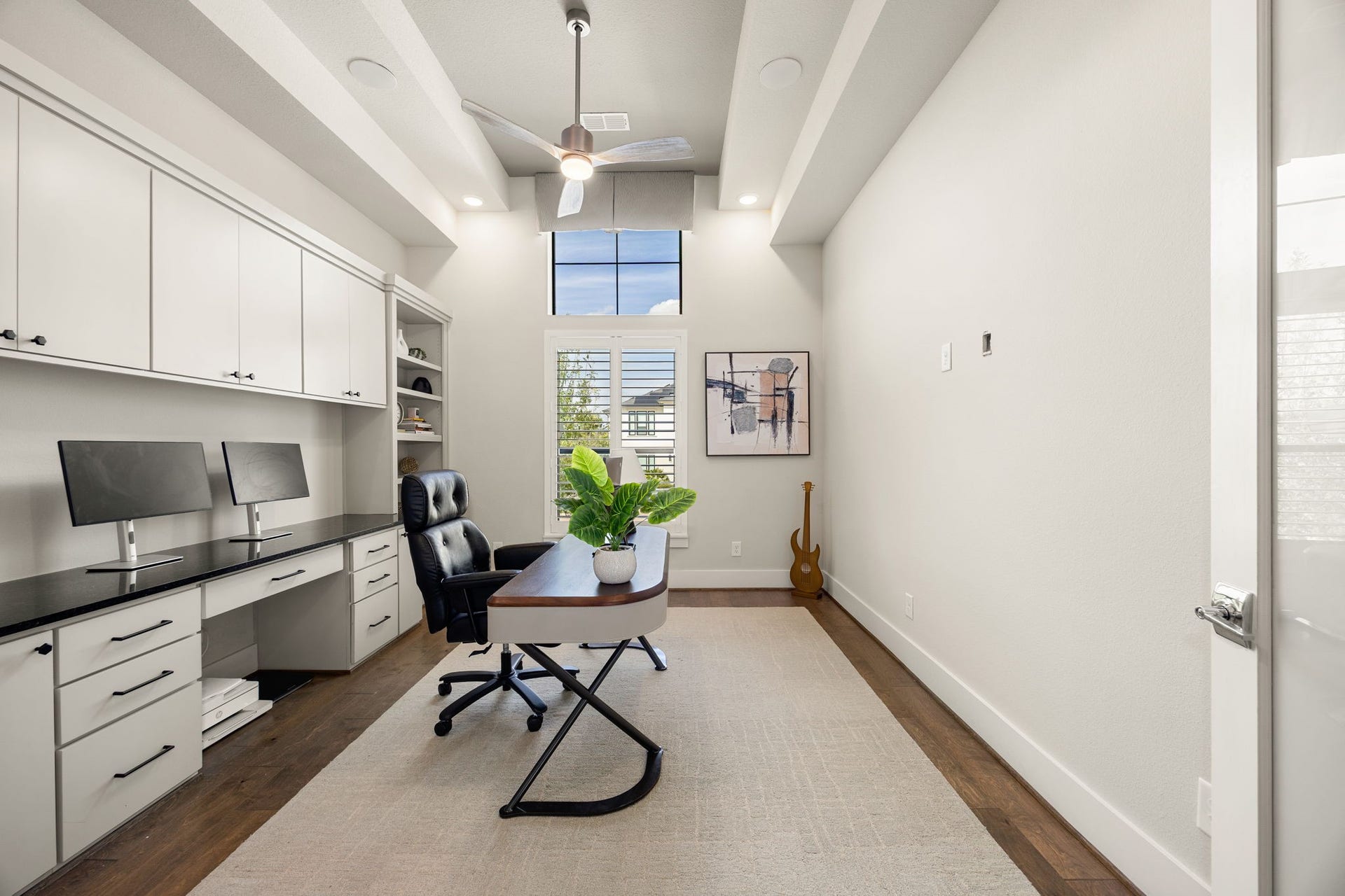 27927 Indigo Ridge Drive, Fulshear, TX 77441 Elevated private home office featuring built-in cabinetry, recessed ceiling, beautiful flooring, and an ideal space for working from home.