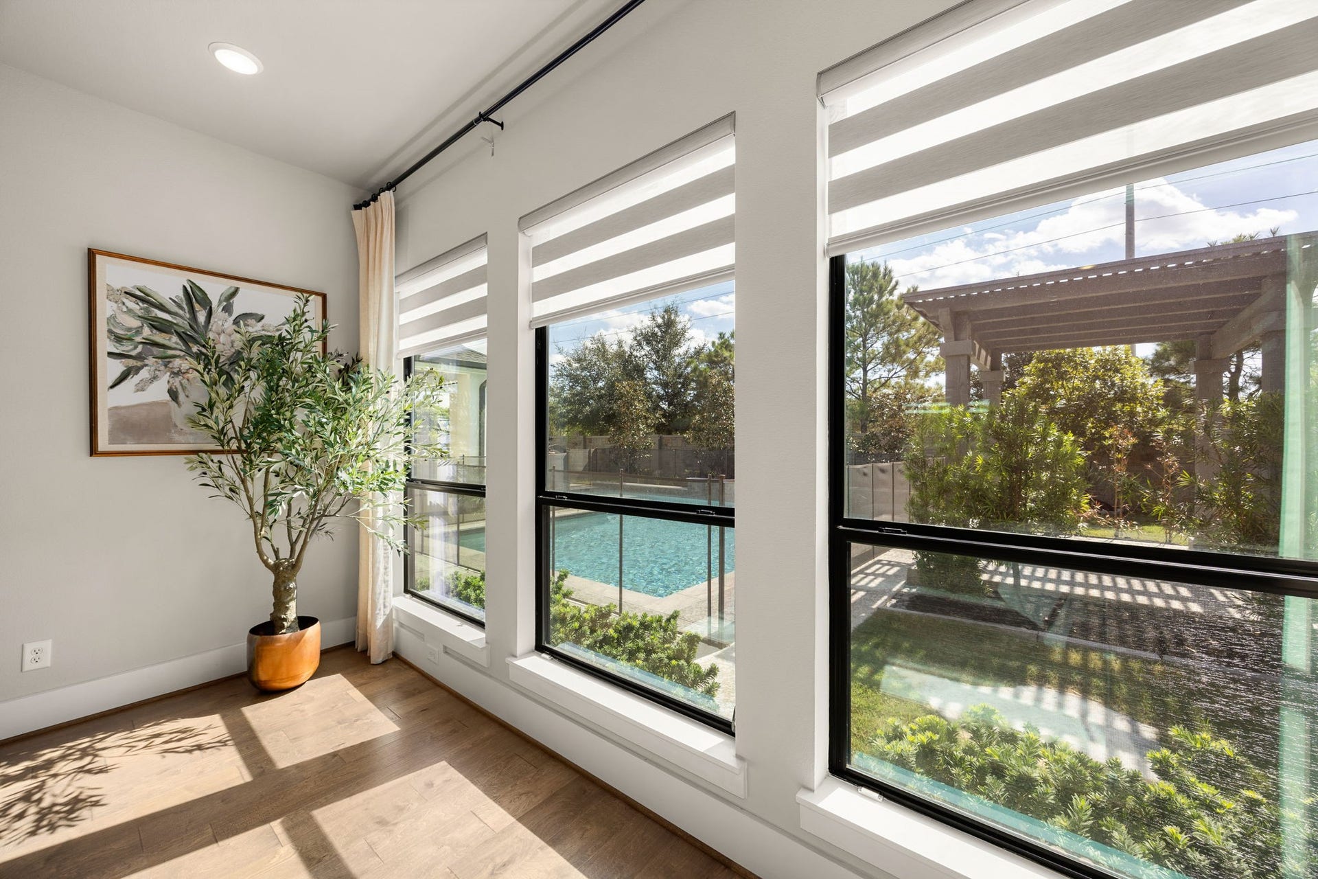 27927 Indigo Ridge Drive, Fulshear, TX 77441 Enjoy peaceful views of the backyard and sparkling pool through the expansive primary suite windows.