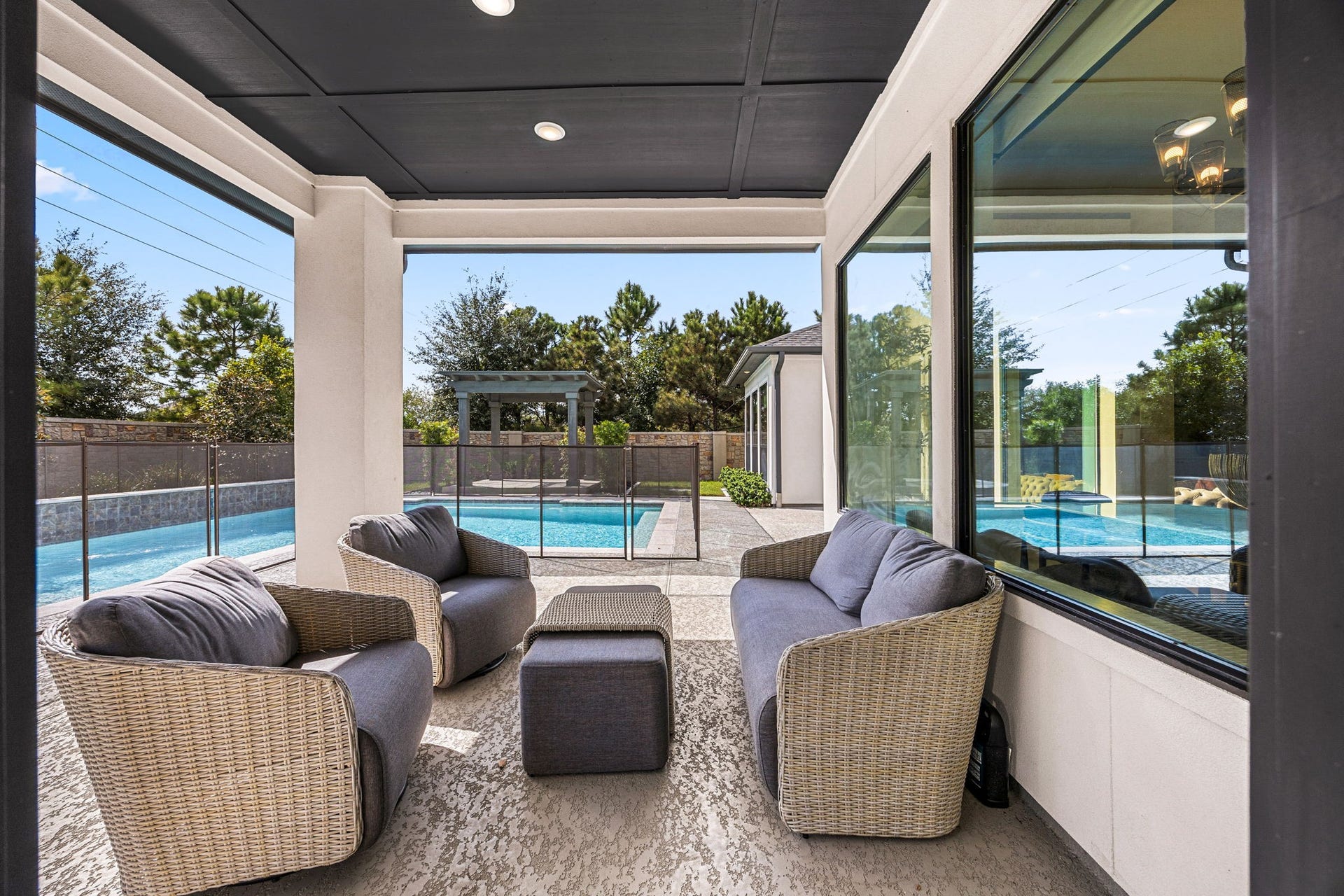 27927 Indigo Ridge Drive, Fulshear, TX 77441 Relax on the spacious covered patio overlooking the sparkling swimming pool and beautifully landscaped backyard.
