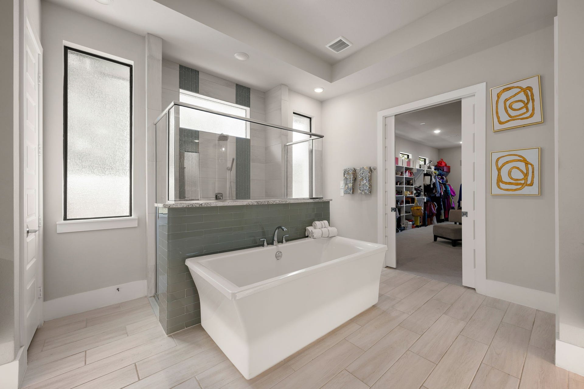 27927 Indigo Ridge Drive, Fulshear, TX 77441 Unwind in the beautiful freestanding soaking tub surrounded by natural light and elegant bathroom finishes.