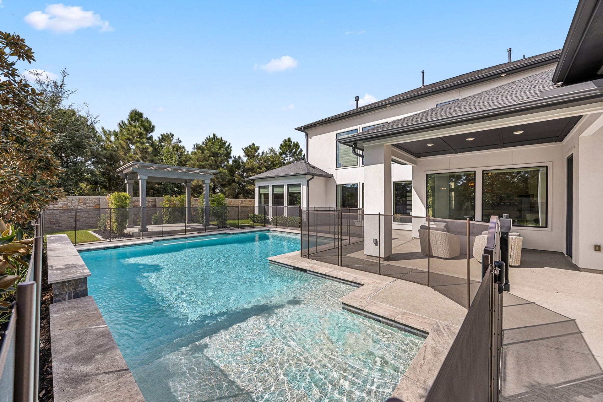 27927 Indigo Ridge Drive, Fulshear, TX 77441 Stunning resort-style swimming pool surrounded by spacious decking, offering the perfect setting for relaxation and entertaining.