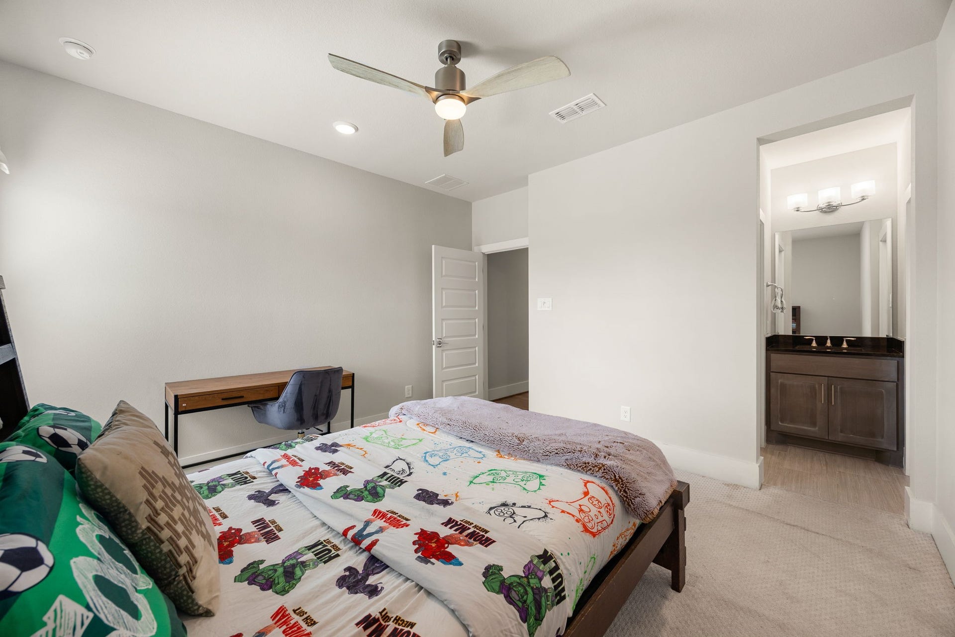 27927 Indigo Ridge Drive, Fulshear, TX 77441 Spacious secondary bedroom with neutral finishes, ceiling fan, an ensuite bathroom, and plenty of room for comfortable living.