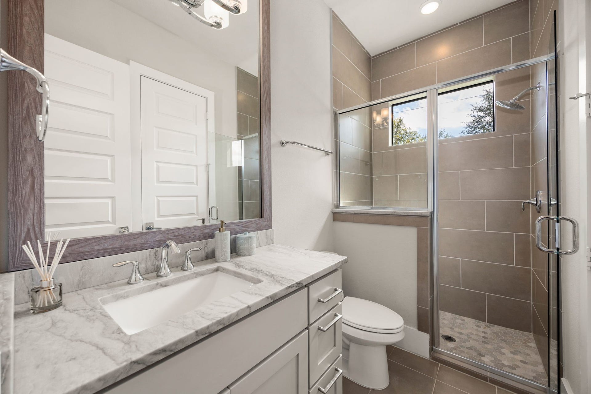 27927 Indigo Ridge Drive, Fulshear, TX 77441 Beautifully designed bathroom featuring a spacious vanity, stylish finishes, and an enclosed shower.