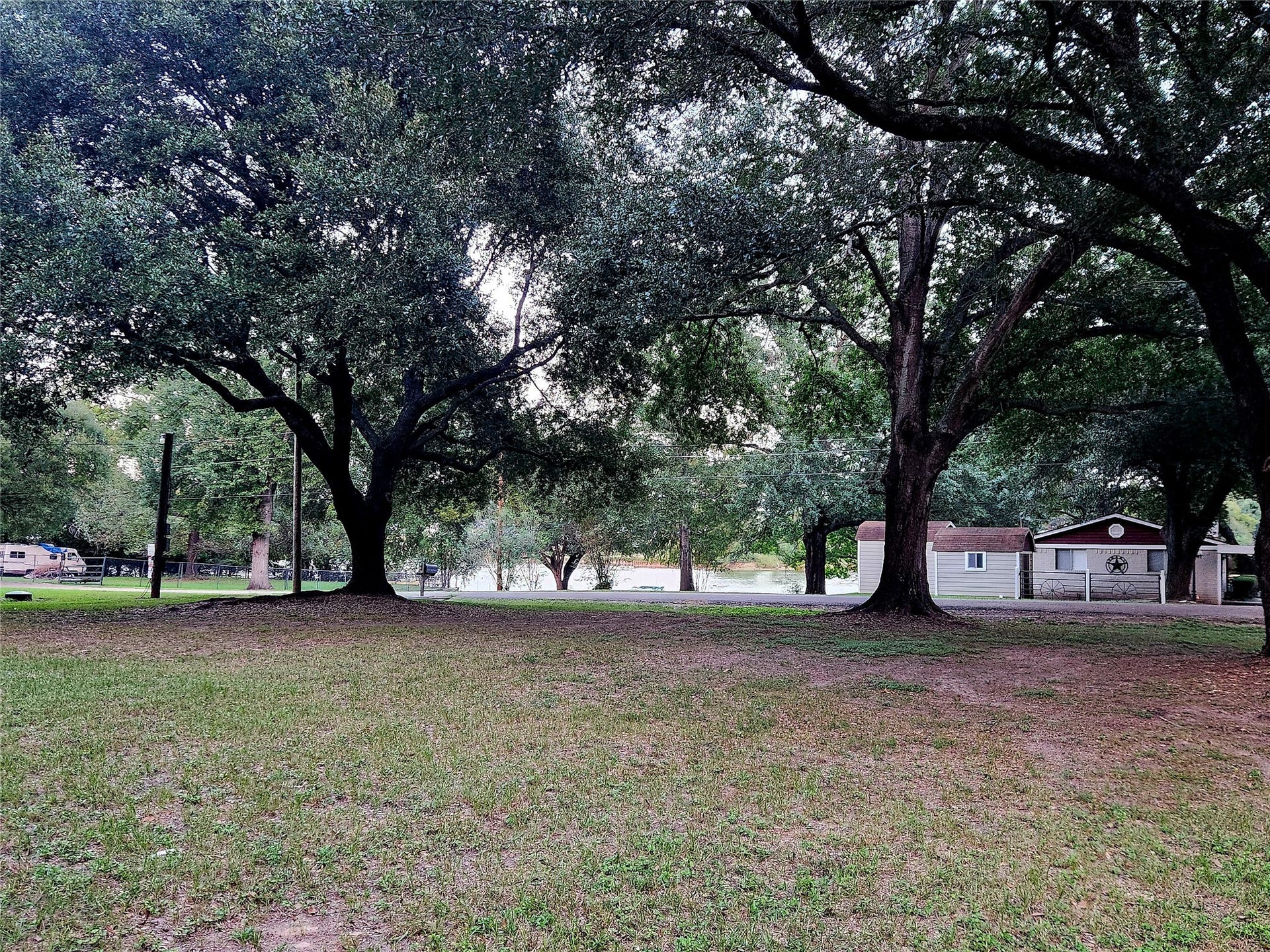 TBD Dream Point, Willis, TX 77318 Standing on the property looking towards the neighborhood park area with view of the lake. This is facing Cozy Cove Lane.
These mature oak trees are absolutely stunning!