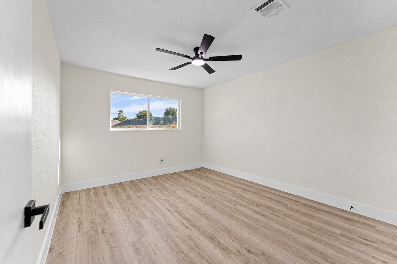 14387 Misty Meadow Lane, Houston, TX 77079 One of the secondary bedrooms, with updated flooring, windows, and a new fan.