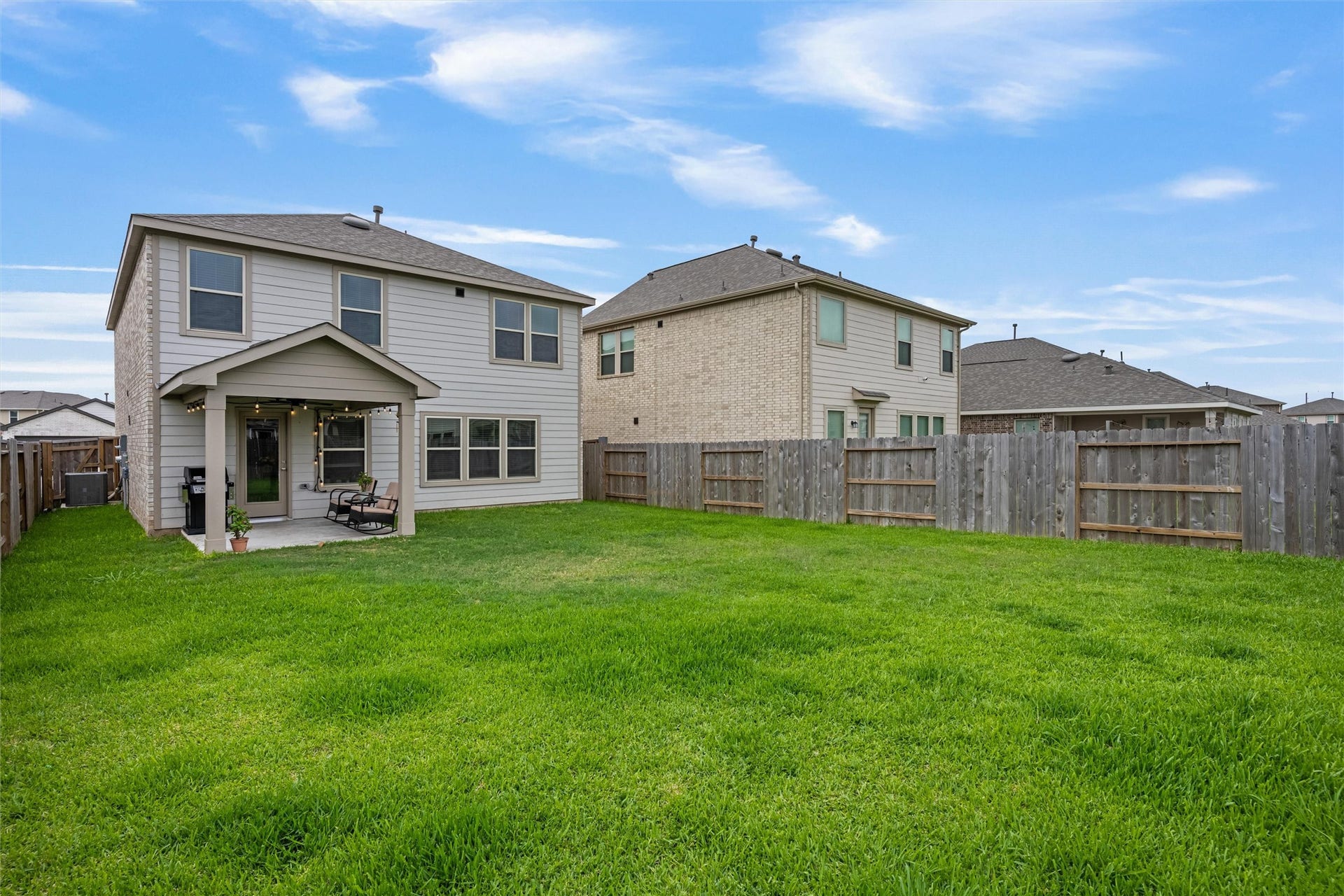 2873 Shimmer Edge Drive, Katy, TX 77493 Generous backyard with a large grassy lawn and full perimeter fencing, offering privacy and plenty of room for recreation, pets, or future outdoor enhancements.