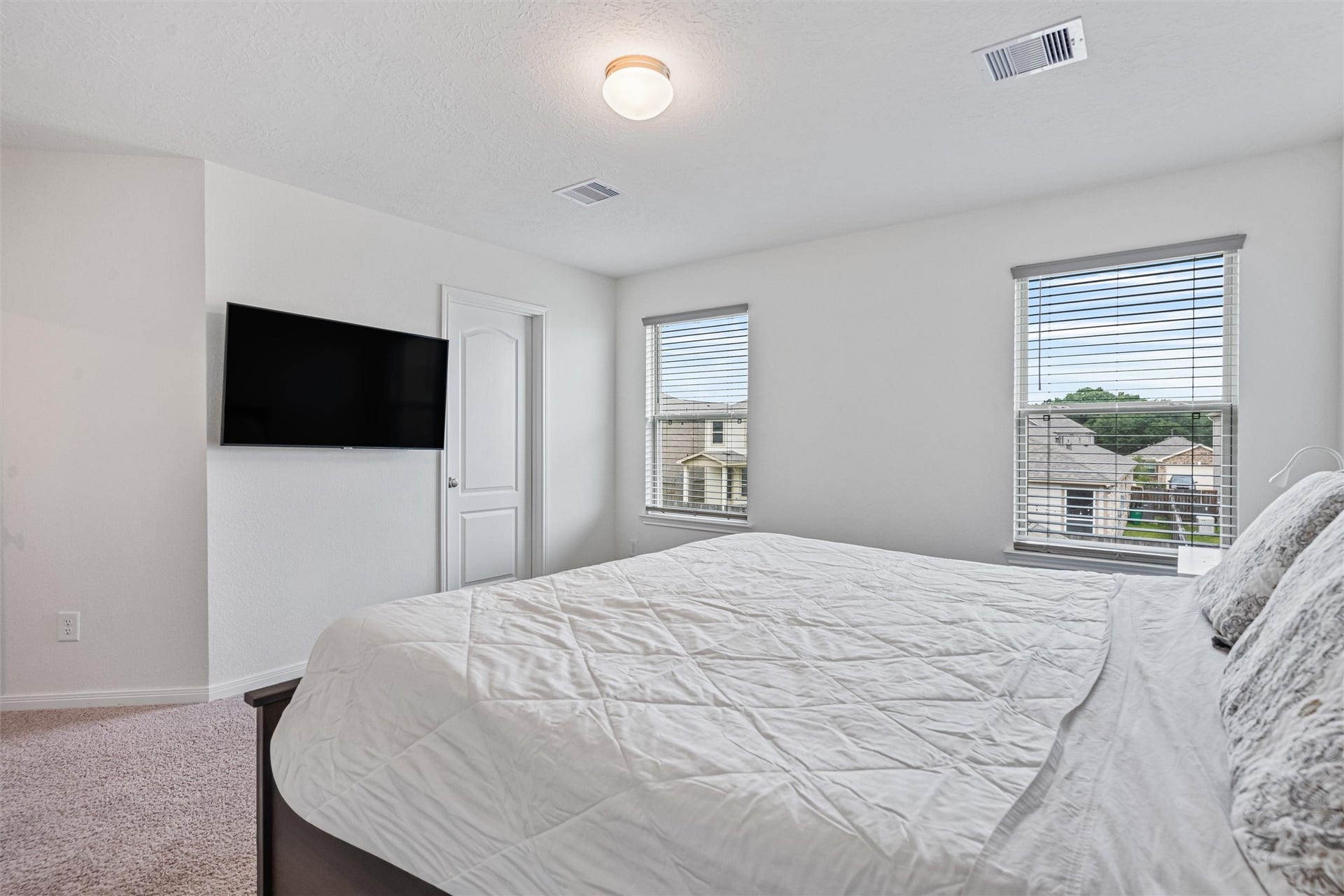 2873 Shimmer Edge Drive, Katy, TX 77493 Alternate view of the primary bedroom showcasing dual windows that flood the space with natural light.