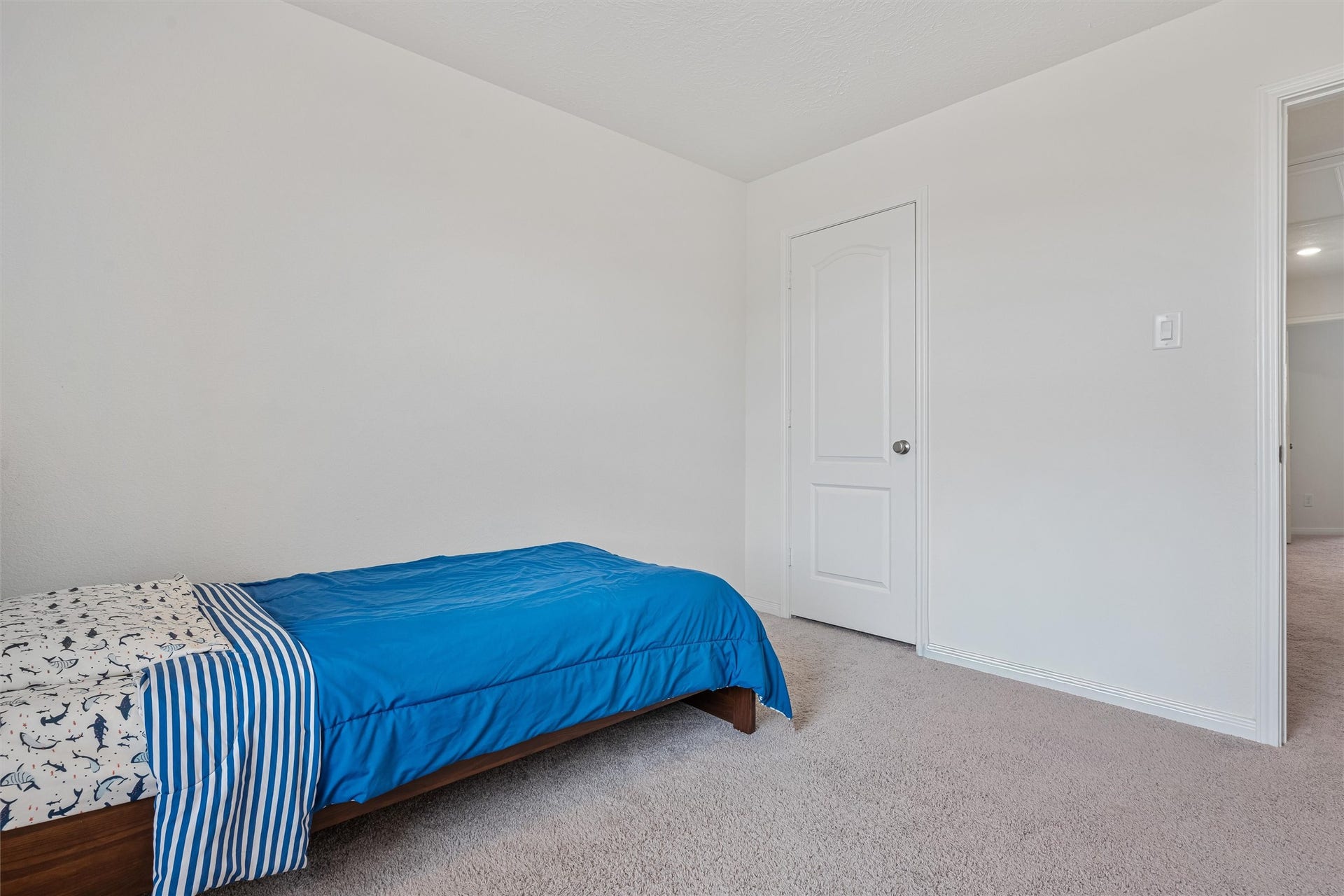 2873 Shimmer Edge Drive, Katy, TX 77493 Alternate view of the secondary bedroom highlighting its functional layout and closet access. The clean lines, soft carpeting, and neutral palette create a versatile space ready to suit a variety of needs.