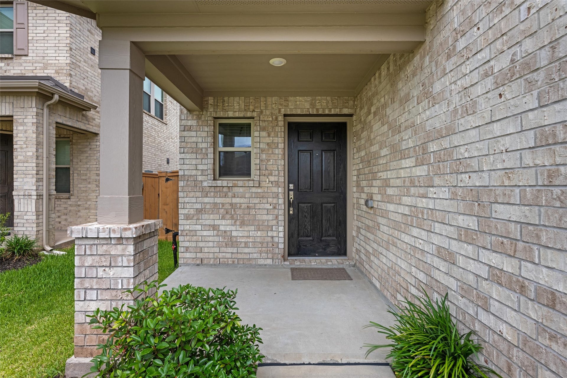 2873 Shimmer Edge Drive, Katy, TX 77493 Inviting walkway leading to the front door, lined with neatly maintained landscaping and decorative stone borders. The covered entry provides protection from the elements and creates a cozy, private arrival space.