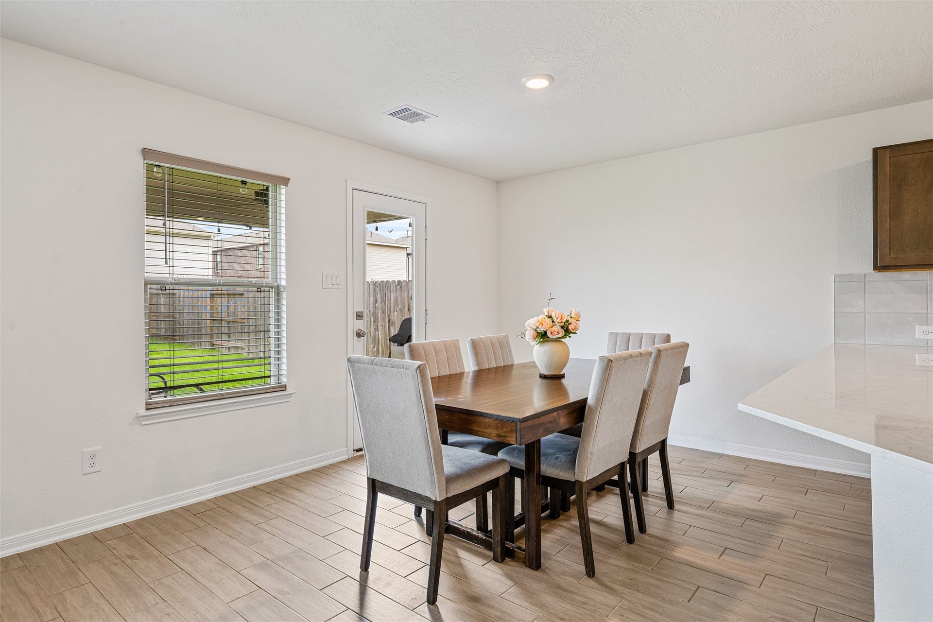 2873 Shimmer Edge Drive, Katy, TX 77493 Alternate view of the dining space showcasing its open layout and proximity to the kitchen. The neutral finishes and continuous flooring create a seamless transition between spaces, enhancing the homes open-concept design.