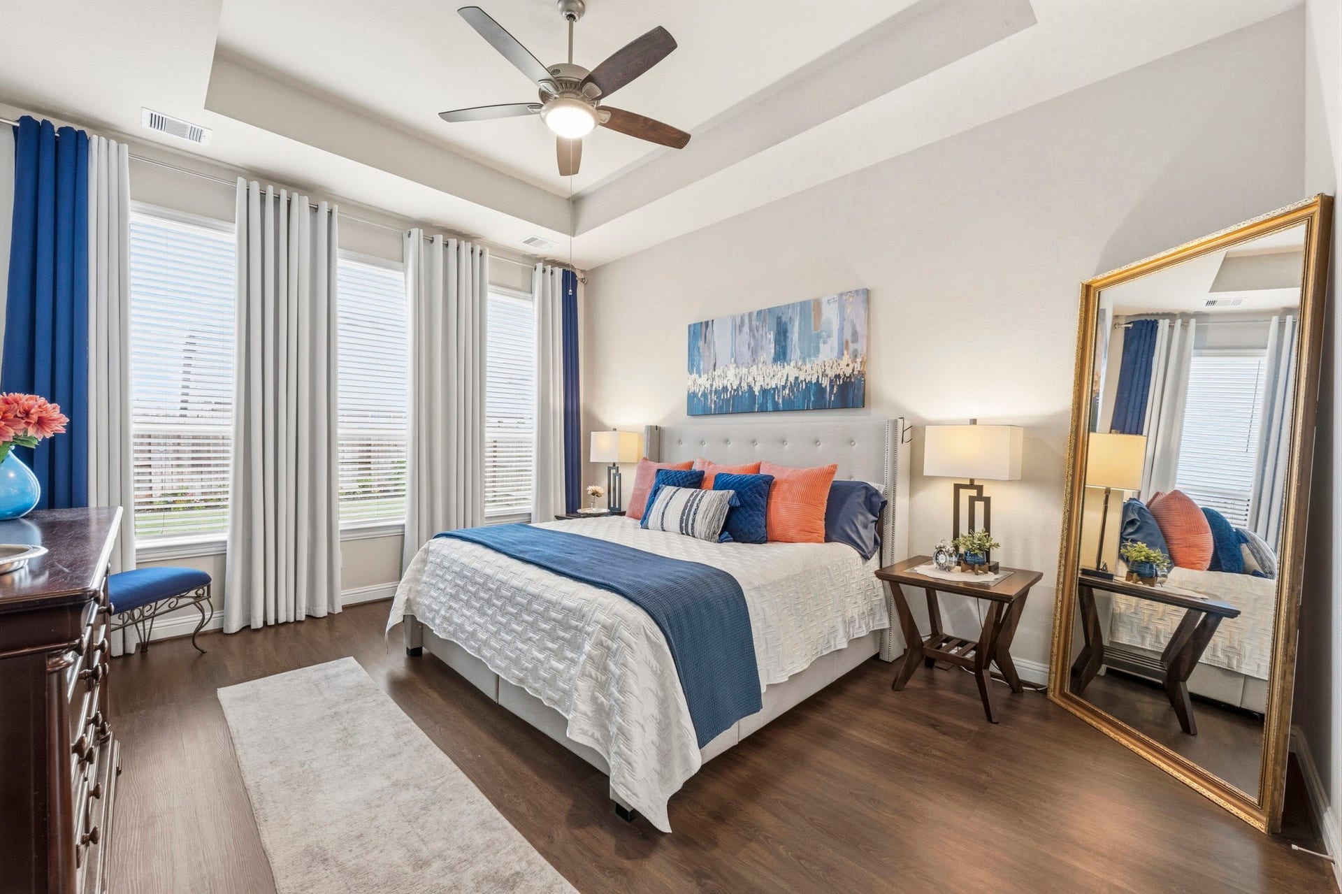 17209 Olive Blossom Court, Conroe, TX 77385 Spacious primary suite featuring a tray ceiling, ceiling fan, and large windows that bring in natural light, creating a relaxing retreat.