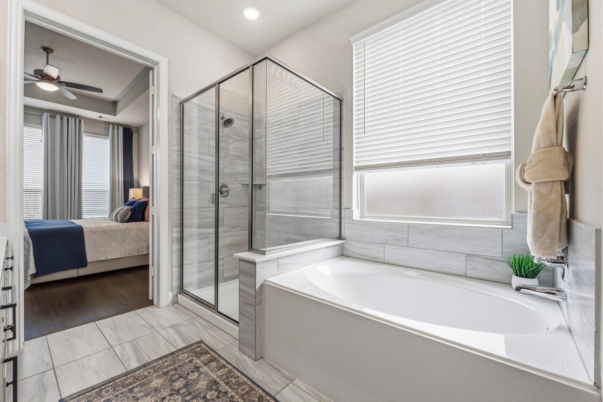17209 Olive Blossom Court, Conroe, TX 77385 Spa-like bath featuring a soaking tub and separate shower, offering a relaxing space to unwind.