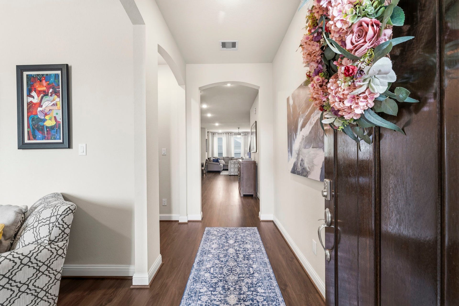 17209 Olive Blossom Court, Conroe, TX 77385 Elegant entry with beautiful luxury vinyl flooring (Nov 2025) flowing throughout the main levelno carpet downstairs.