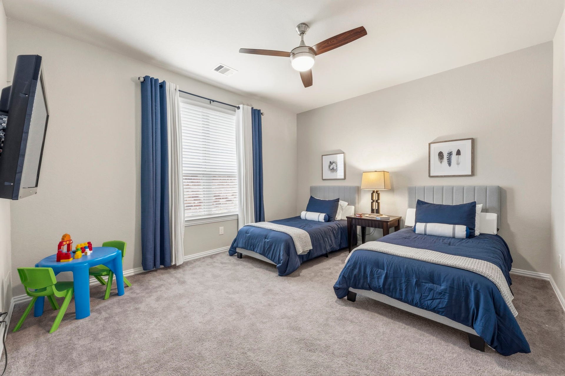 17209 Olive Blossom Court, Conroe, TX 77385 Generously sized secondary bedroom with a large walk-in closet, ceiling fan, and window providing natural light.